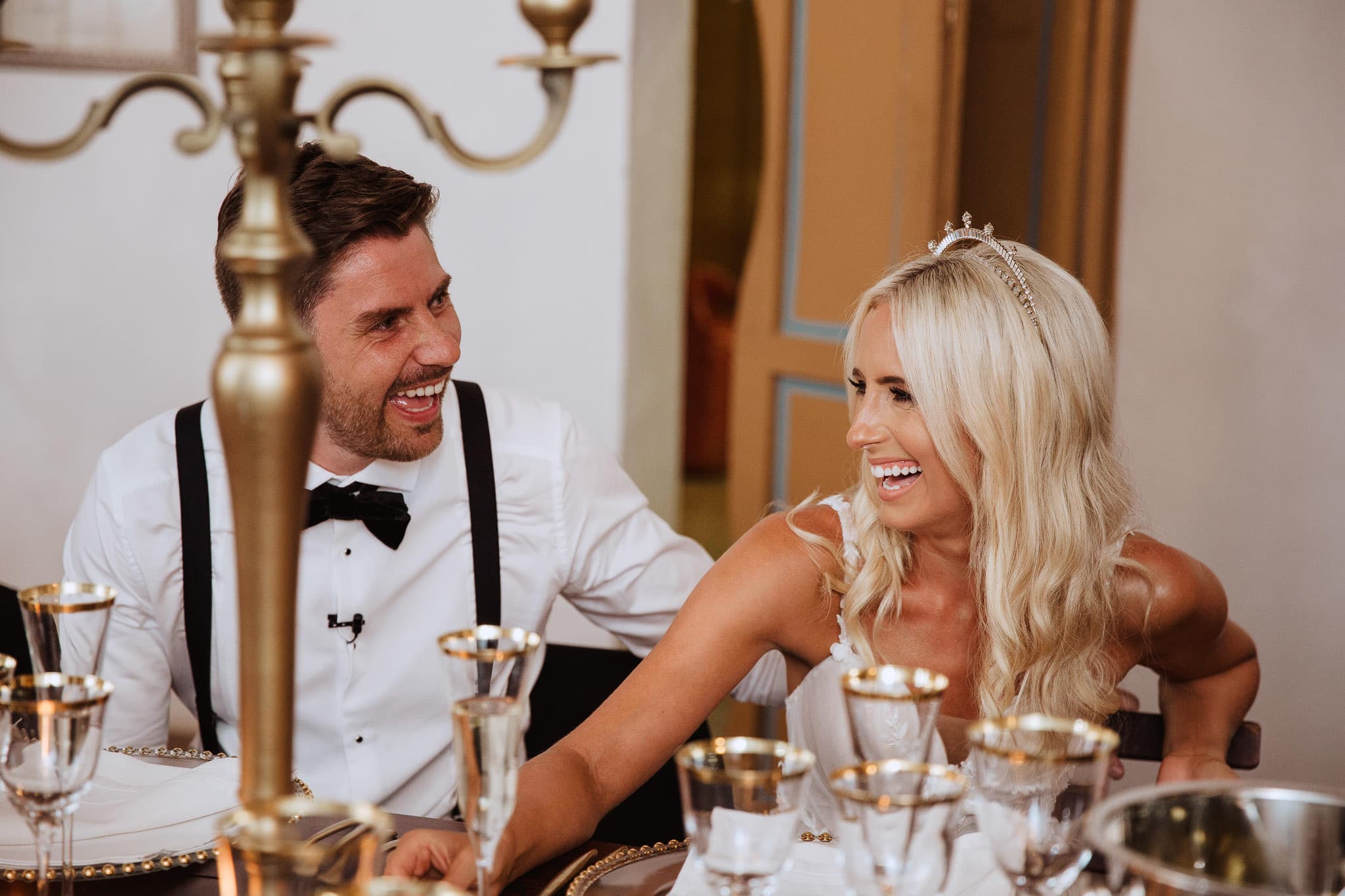 bride and groom laughing at speeches