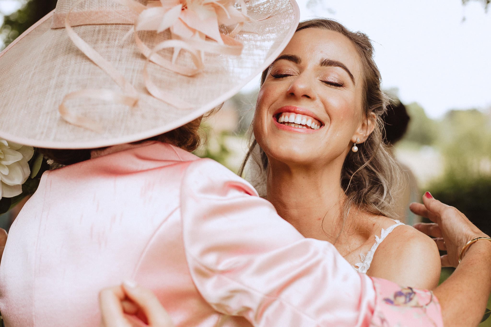 close up of a happy bride hugging her new mother in law