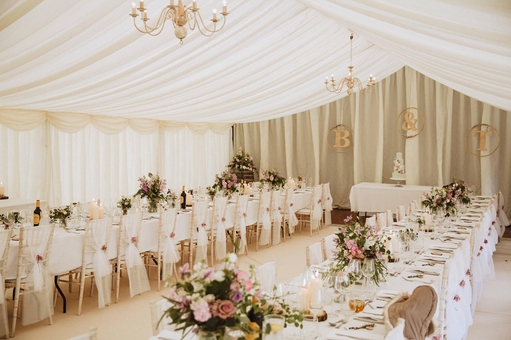 elegant wedding marquee with pink flowers and white decor