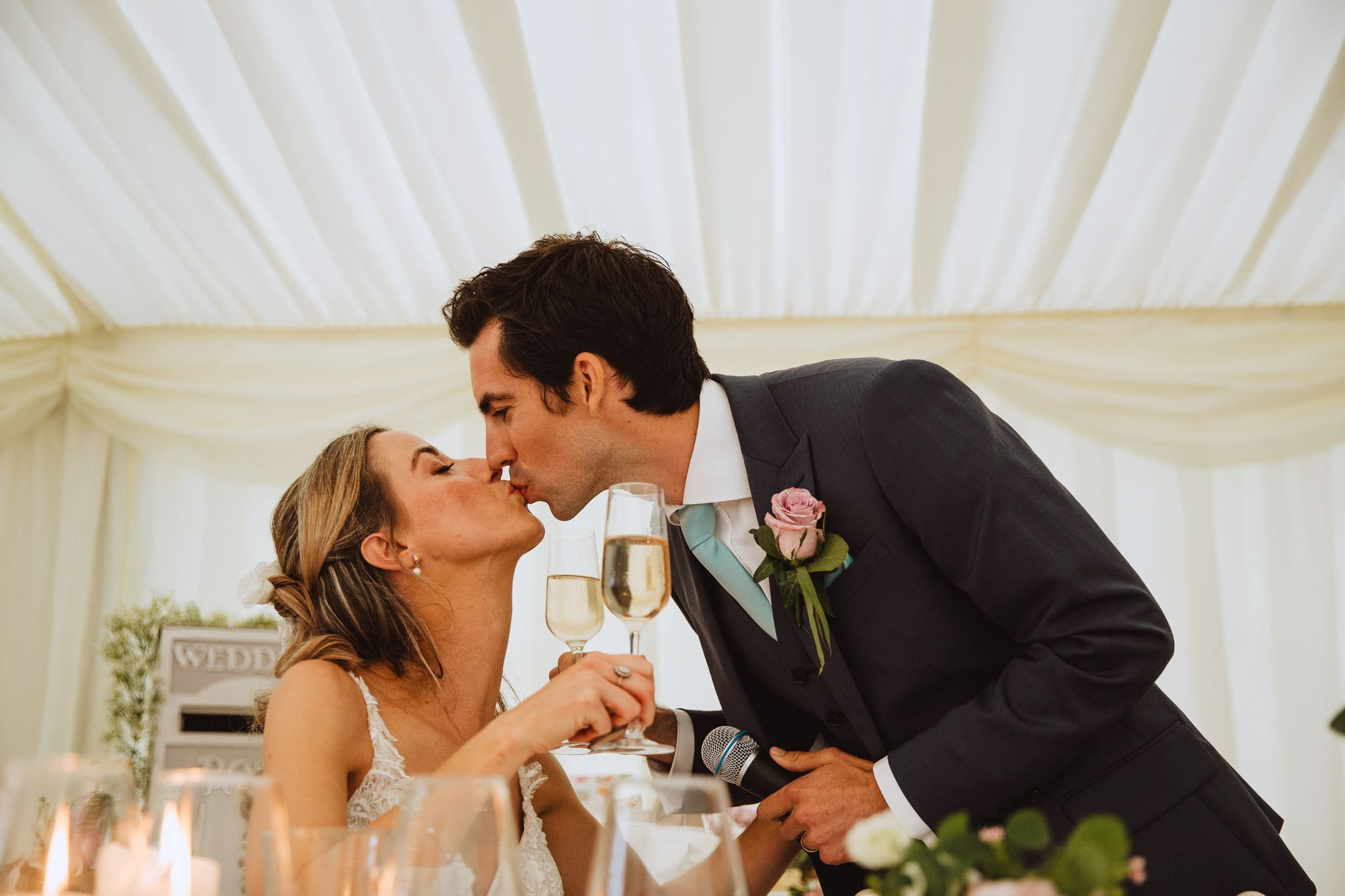 candid kiss after the groom's speech