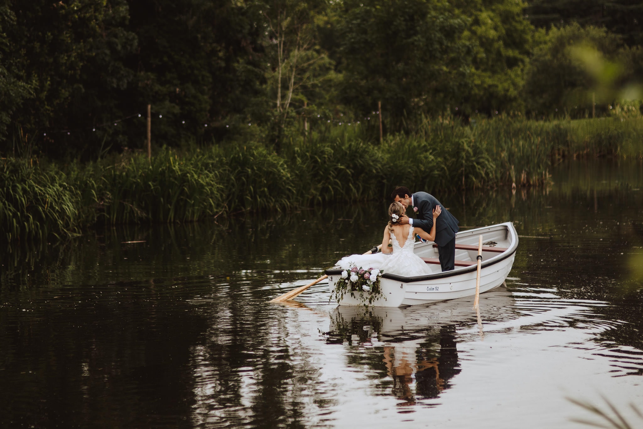 bride and groom in a rowing boat
