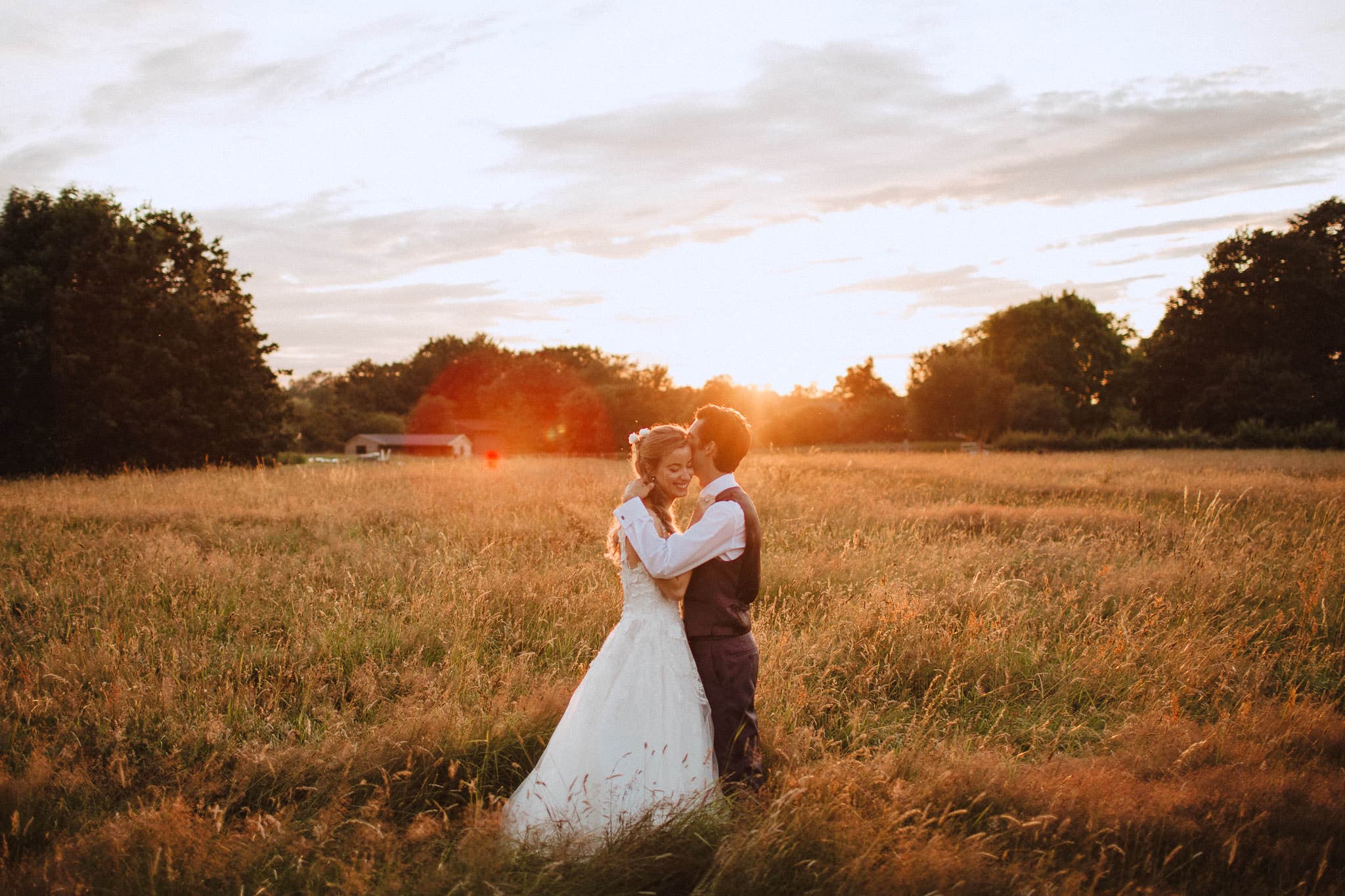 sunset portrait of bride and groom in a field by Leicestershire wedding photographer