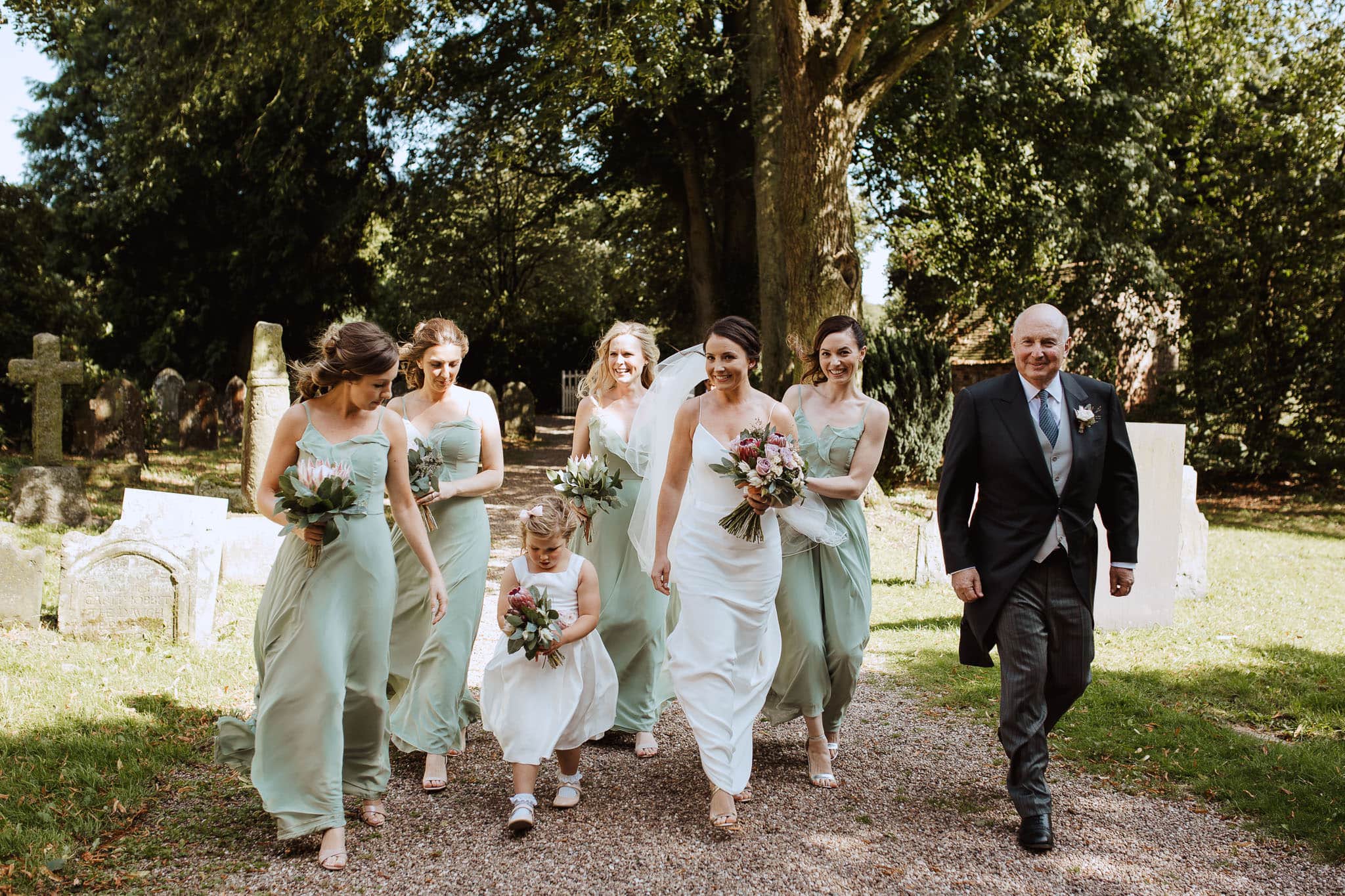 bridal party walking to All Saints Church, Ashbourne Derbyshire Wedding