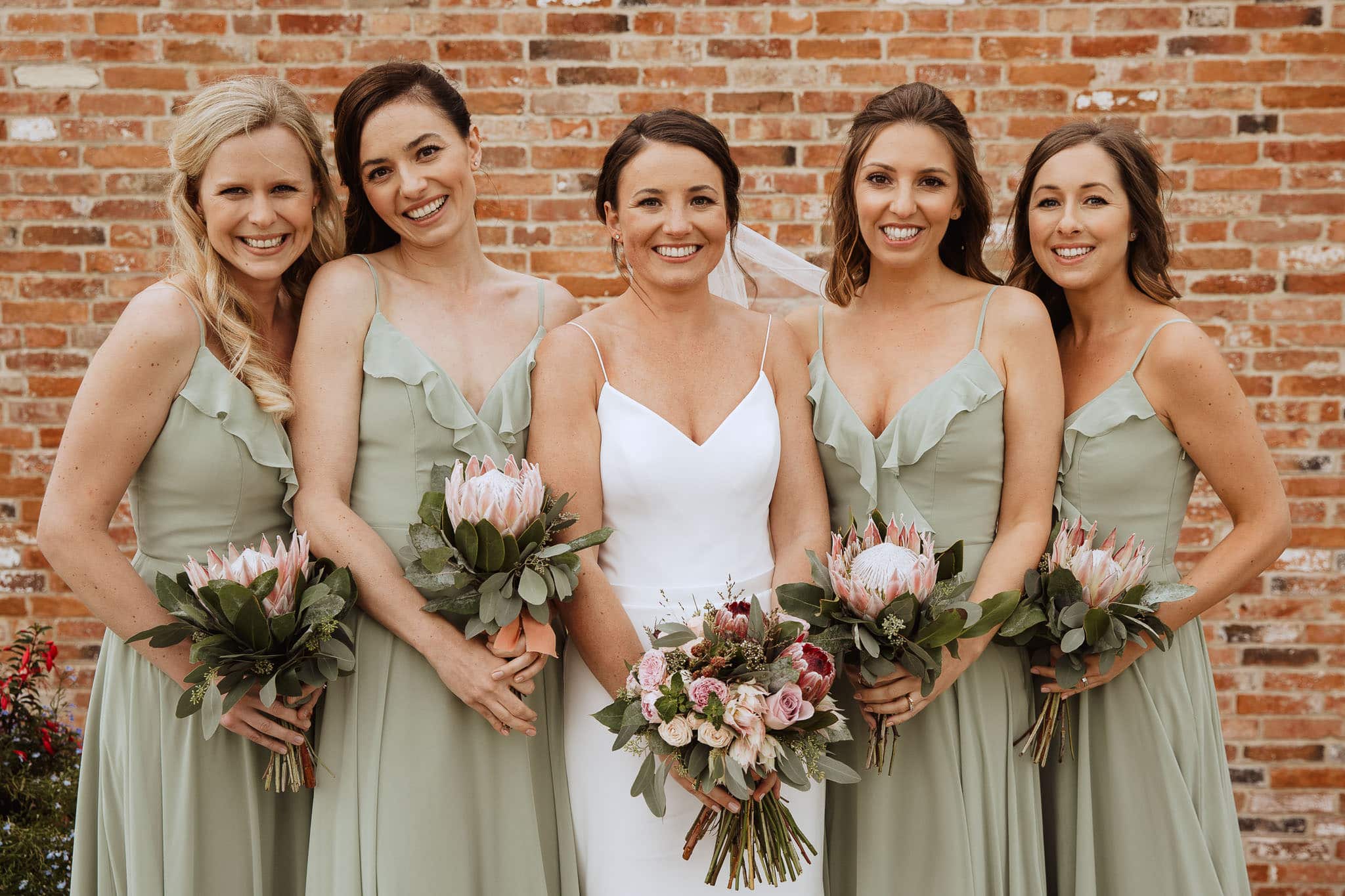 Suzanne Neville bride with bridesmaids in Sage green