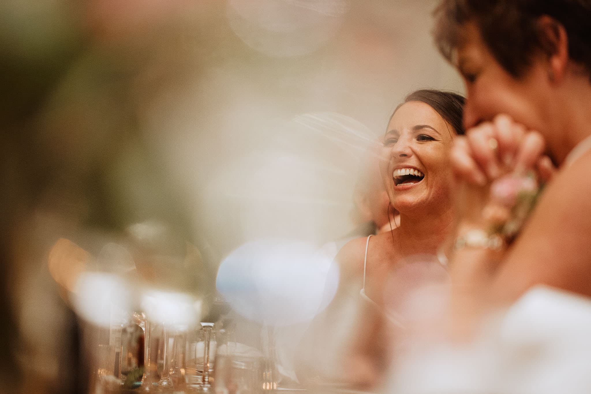 close up of bride laughing at speeches