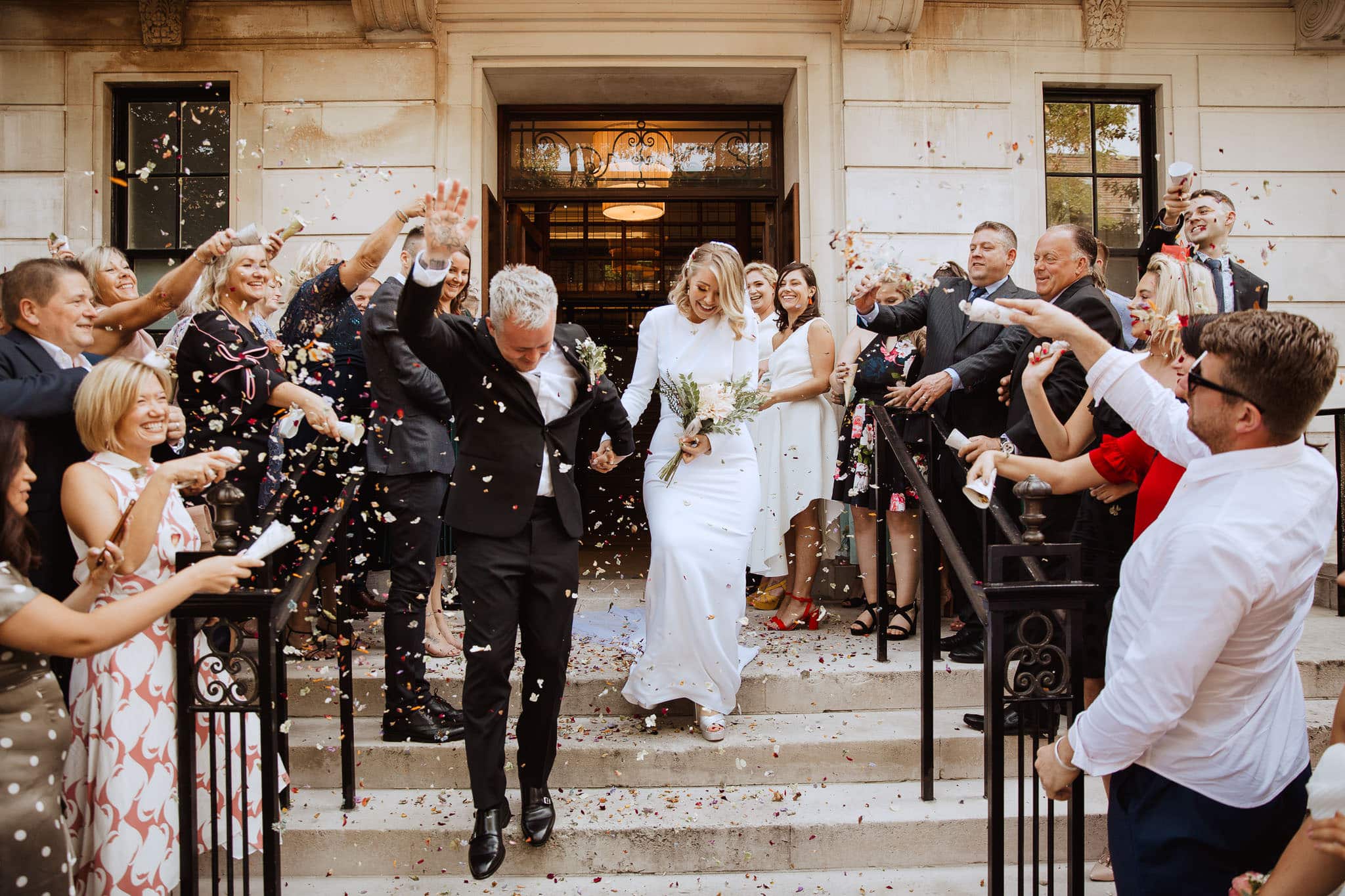confetti on the steps of Town Hall Hotel Wedding, London