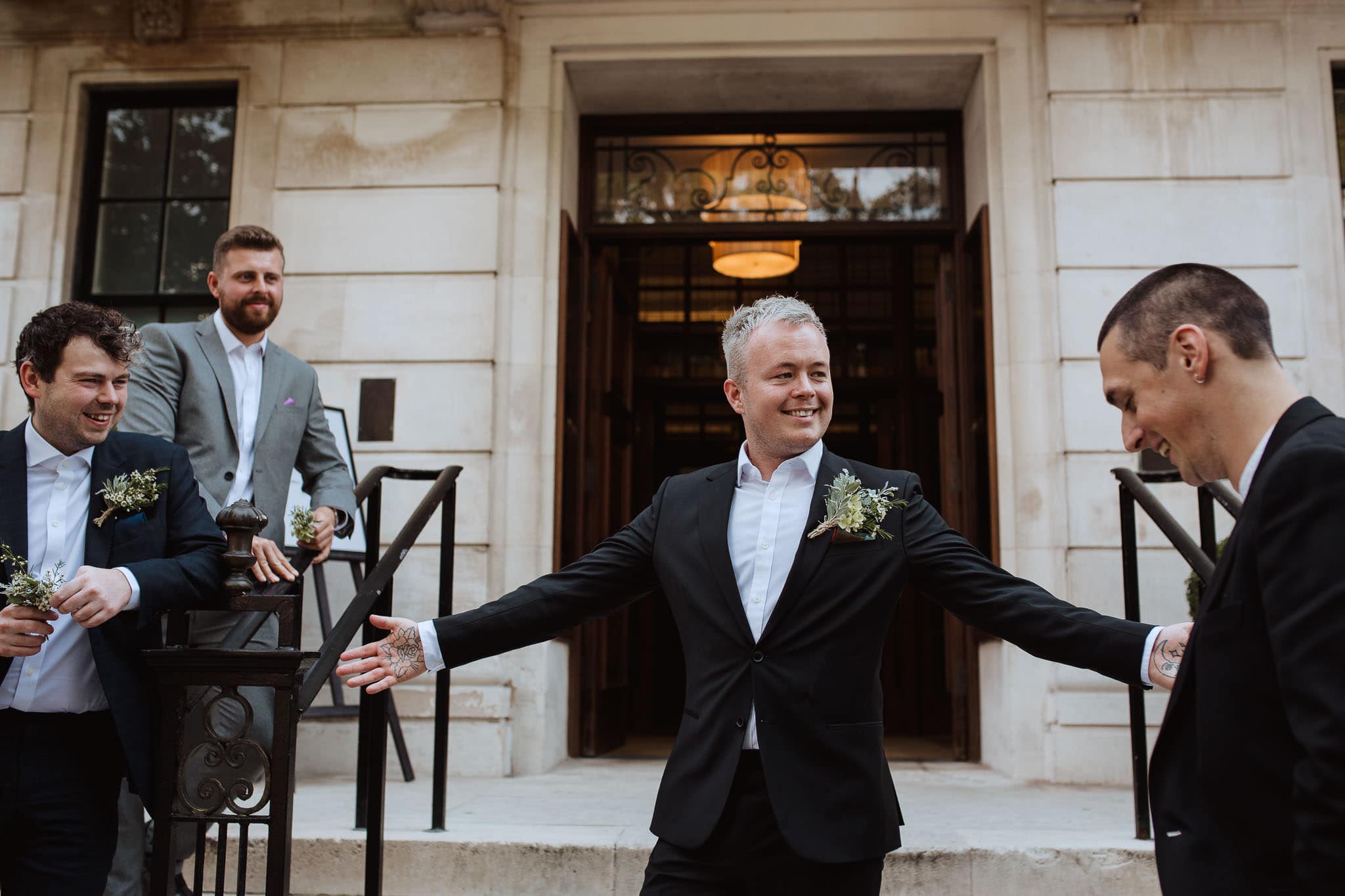 groom on the steps of Town Hall Hotel Wedding, London