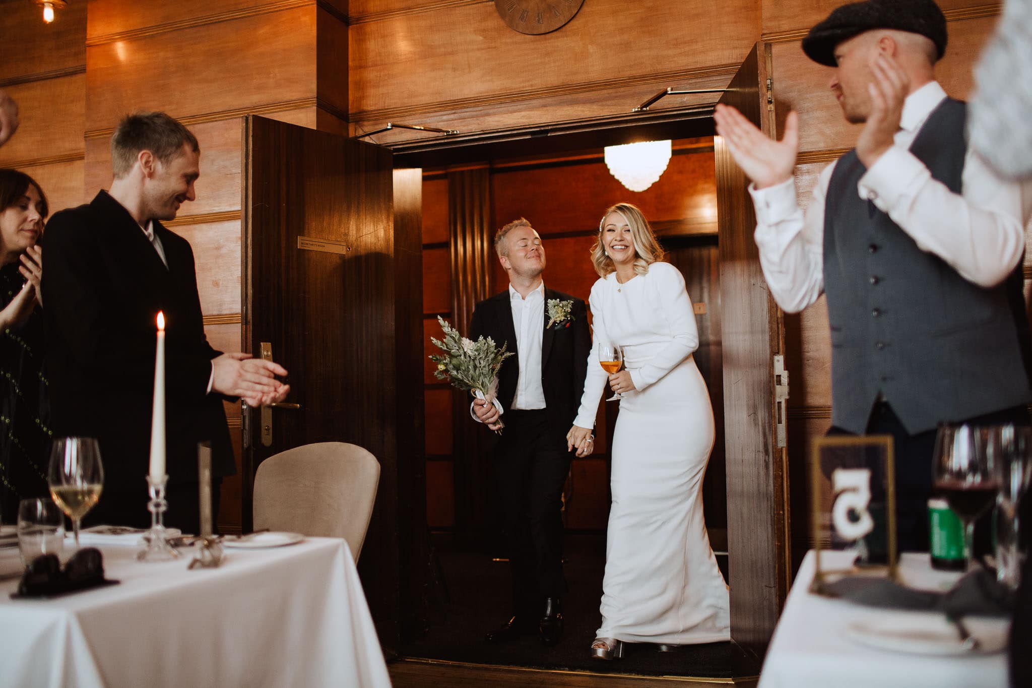 bride and groom's entrance to wedding breakfast