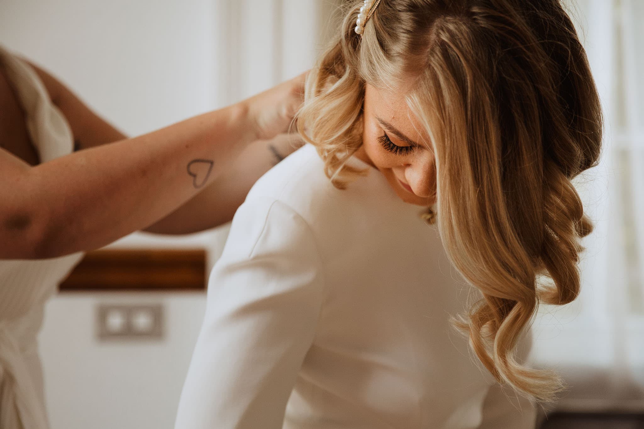 close up of bride putting on Stella McCartney wedding dress for Town Hall Hotel Wedding, London