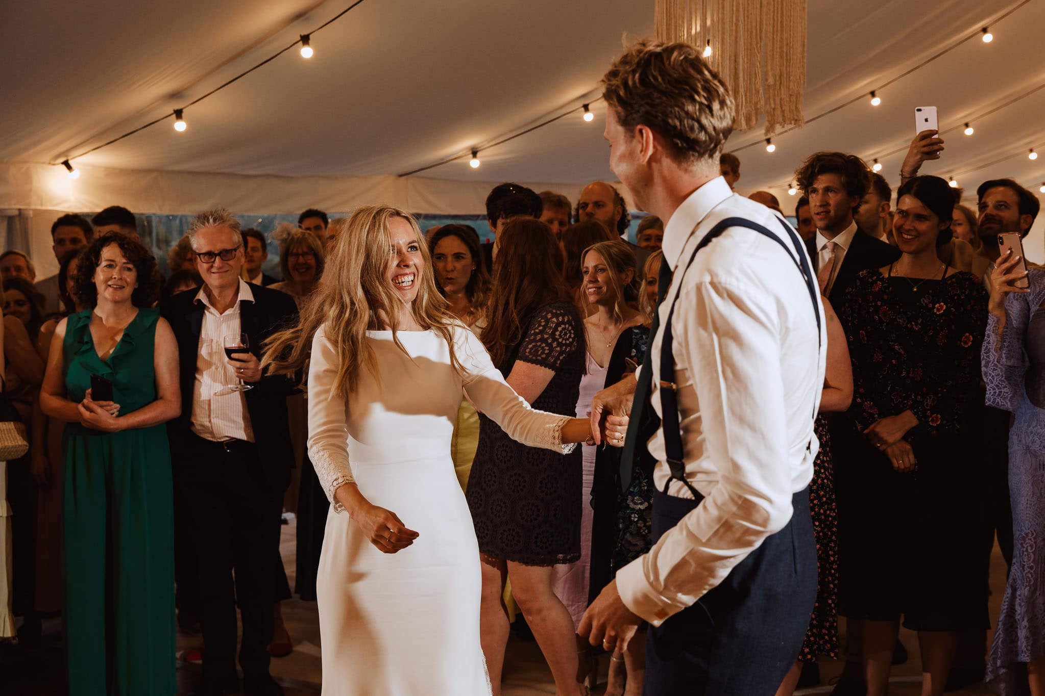 bride and grooms dancing in the marquee