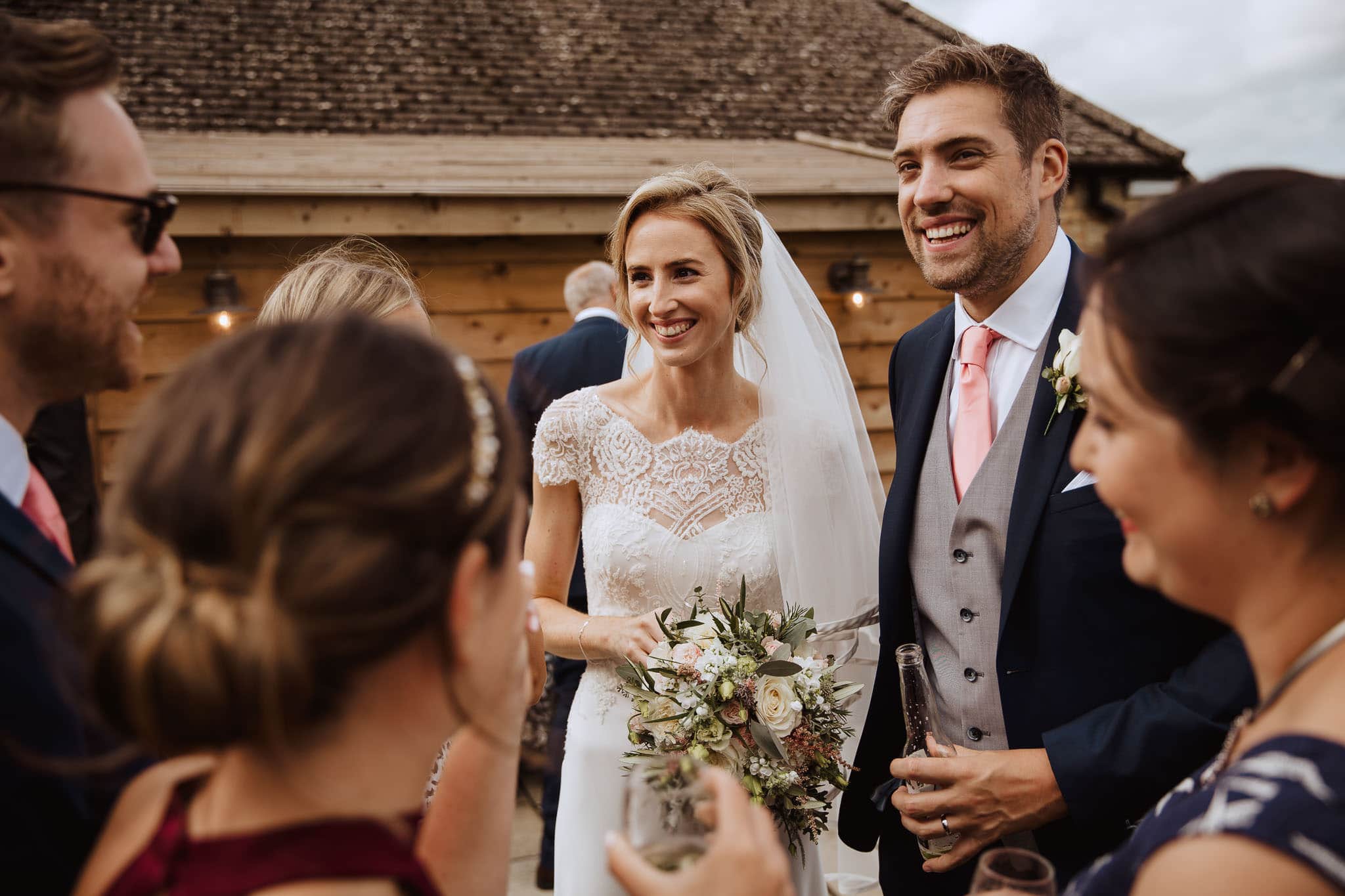 bride and groom with guests at Lapstone Barn Wedding venue The Cotswolds