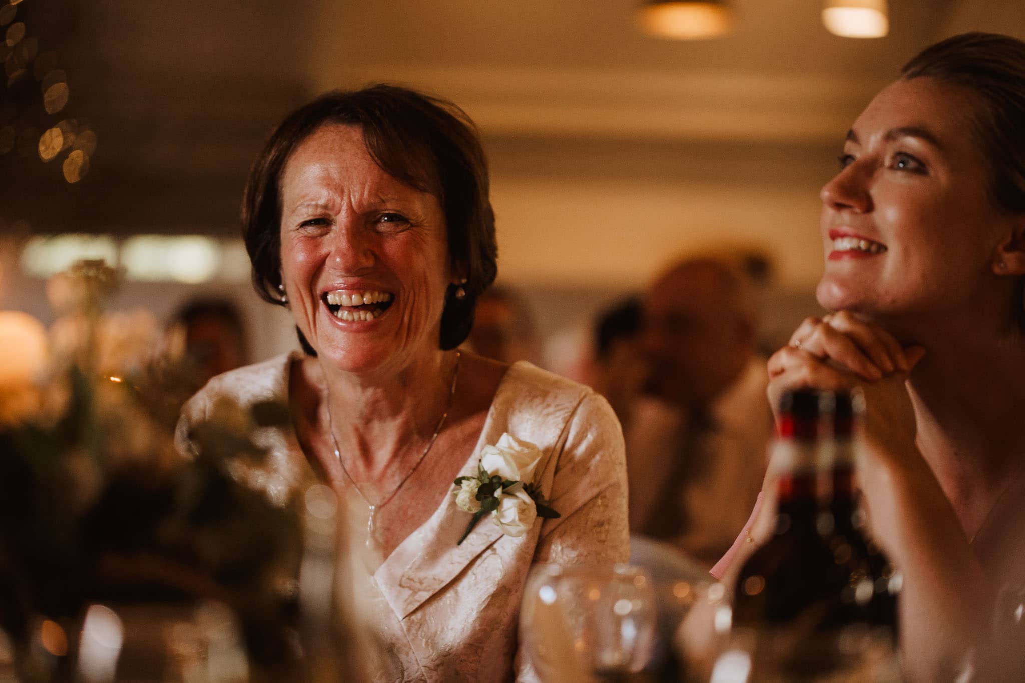 mother of the bride laughing at wedding speech