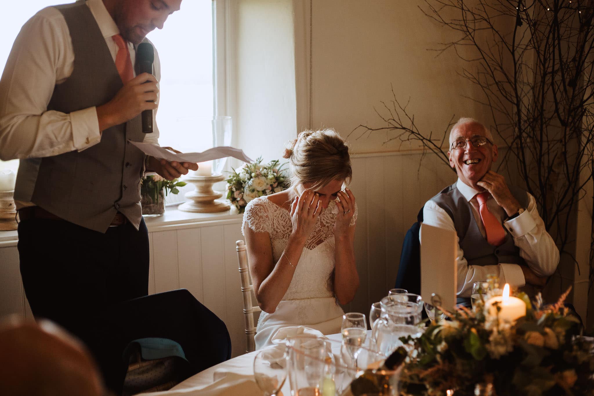 bride with head in hands during speeches