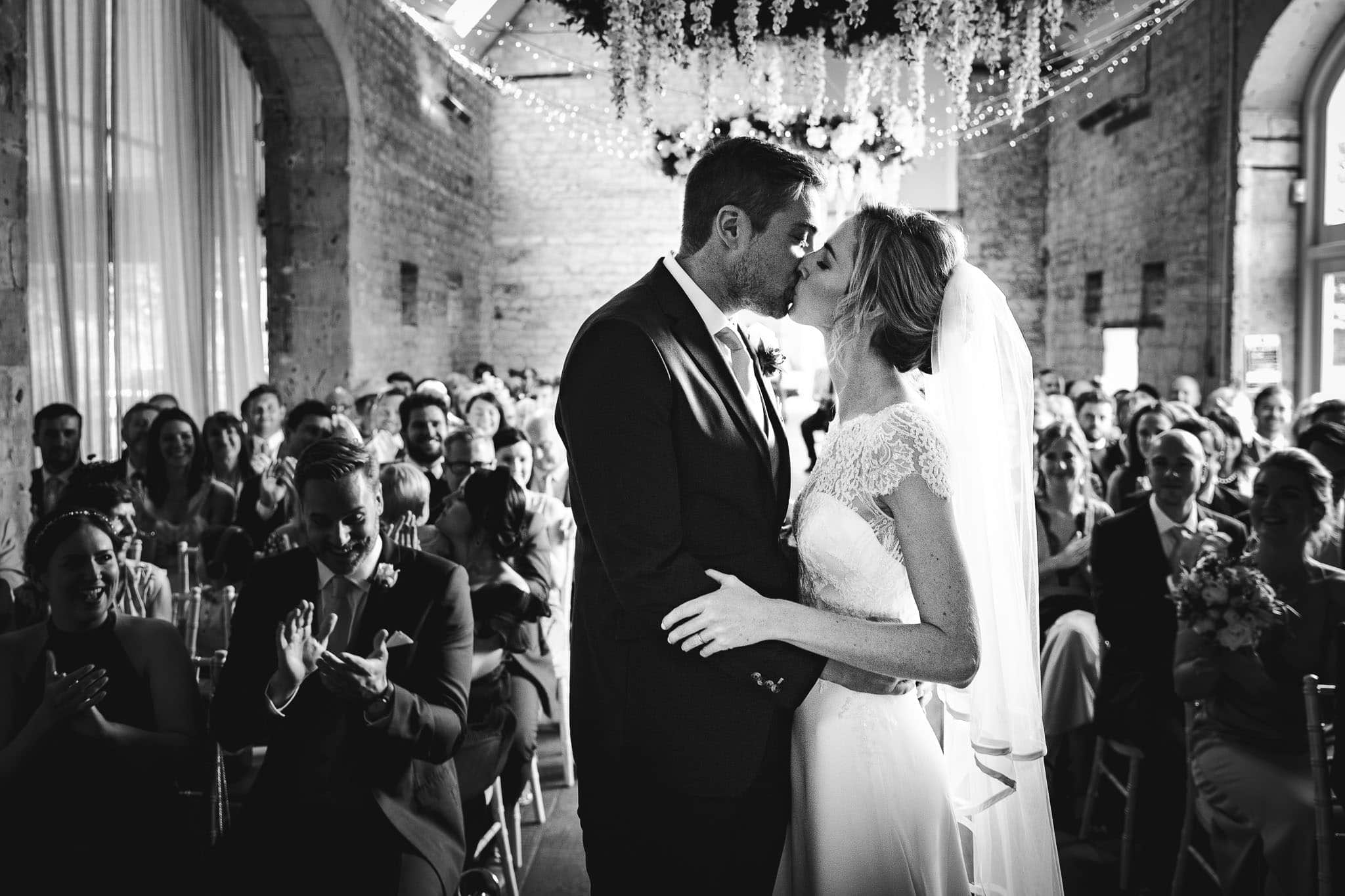 black and white photo of the first kiss at Lapstone Barn Wedding