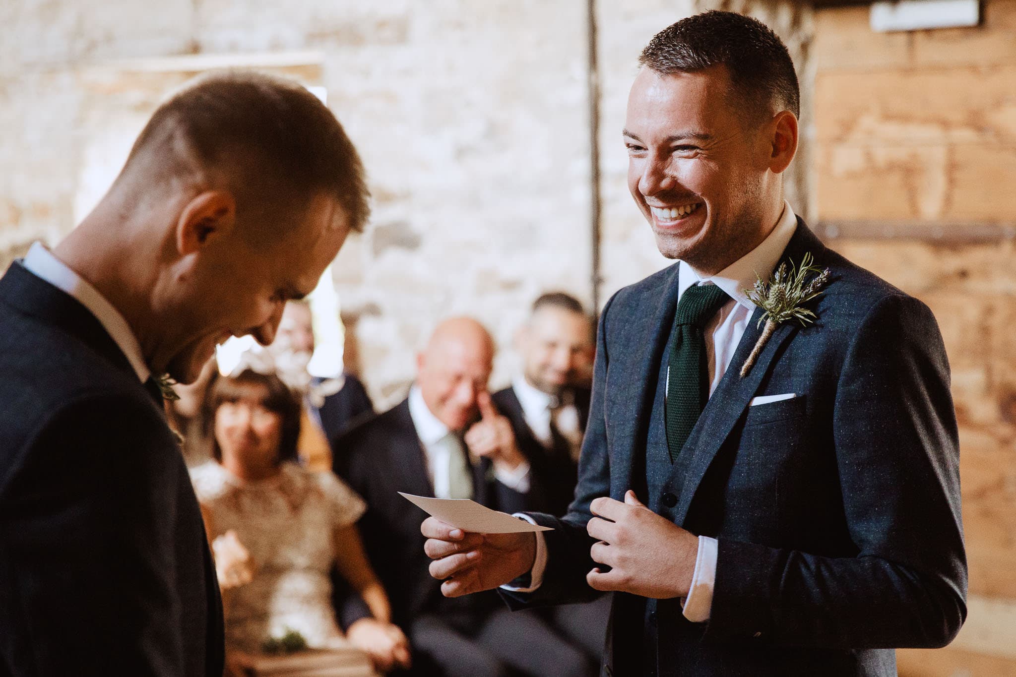 close up of groom laughing during wedding vows