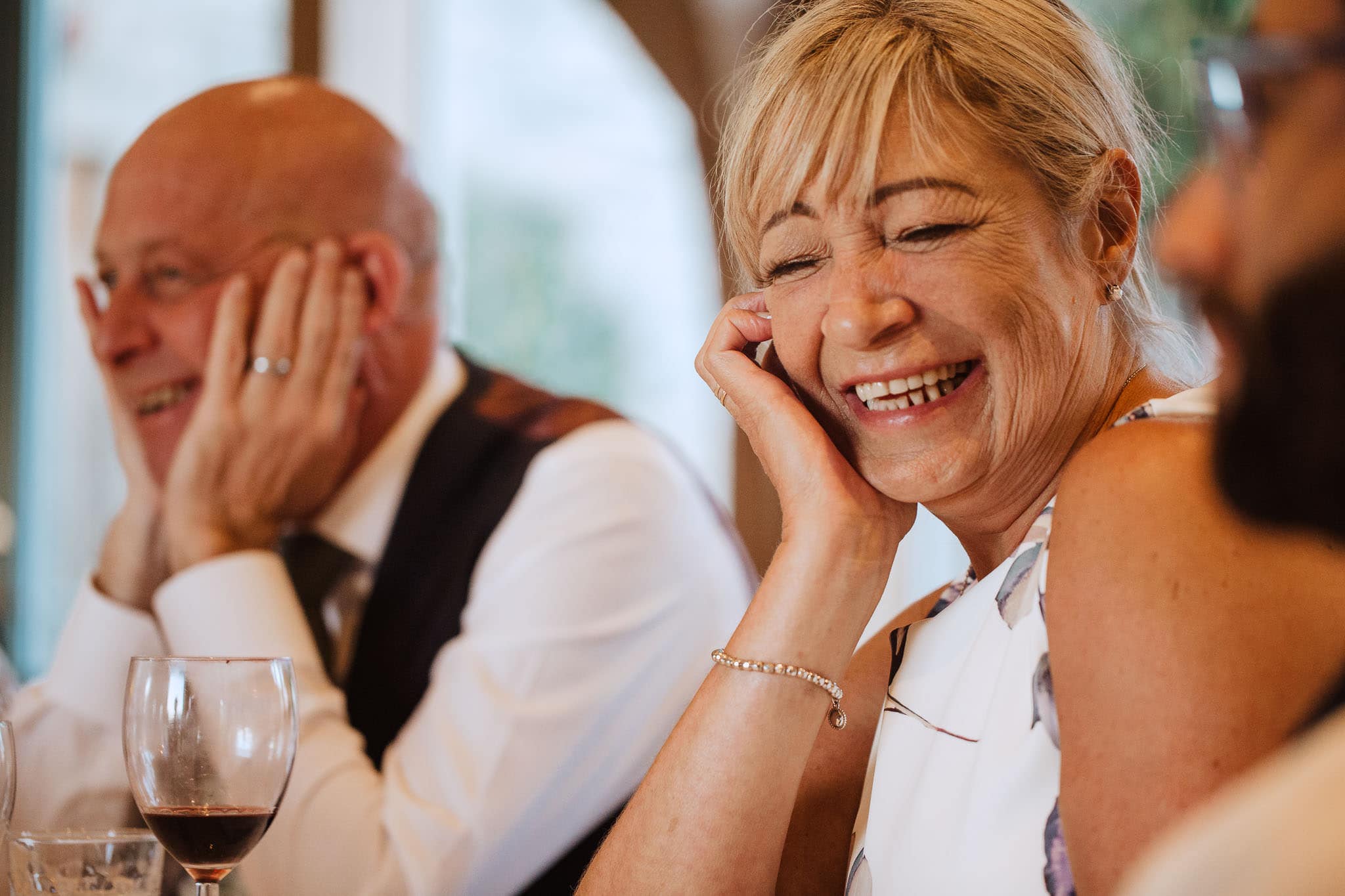 close up of Mum laughing during best  man's speech