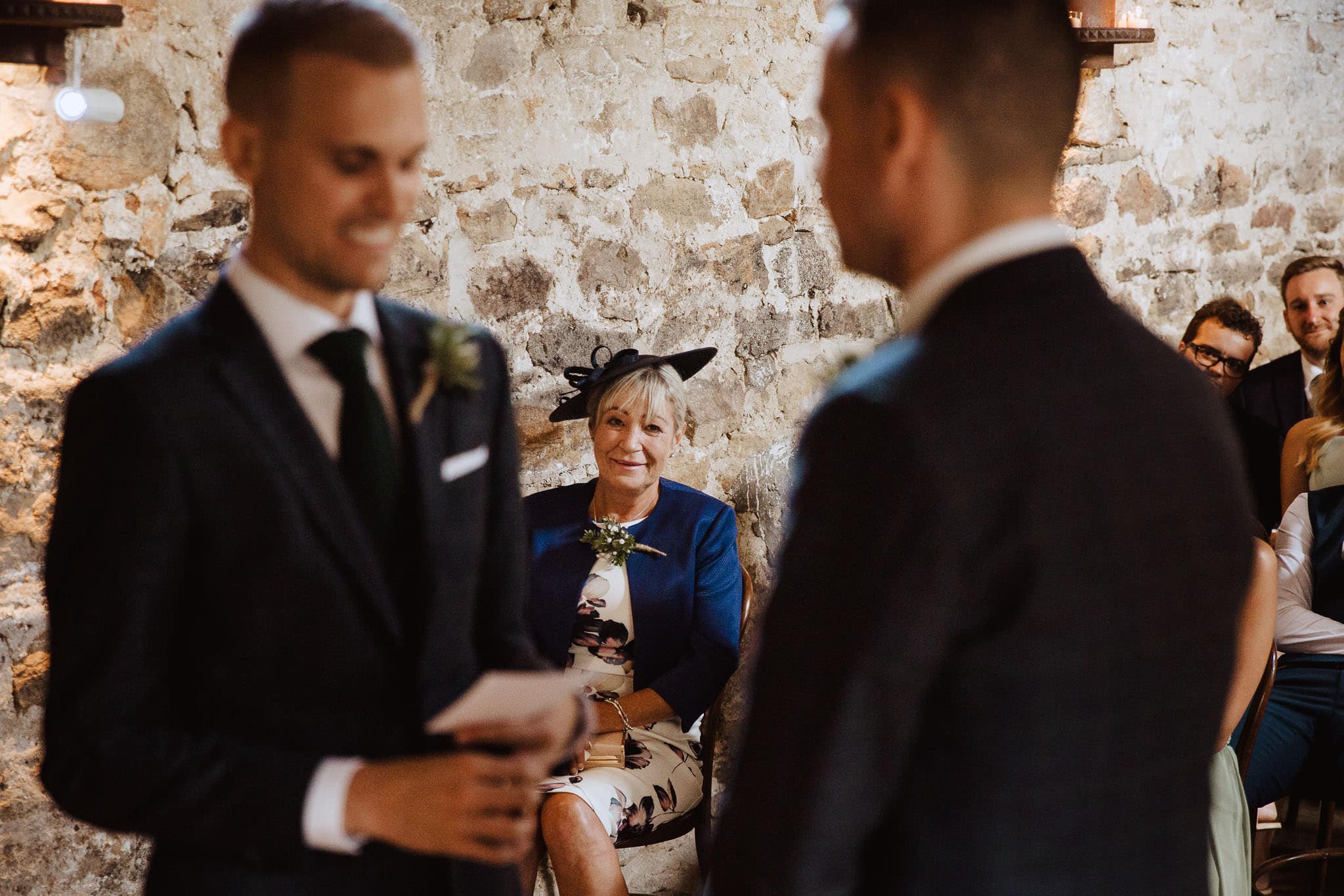 photo of proud mother of the groom during wedding vows