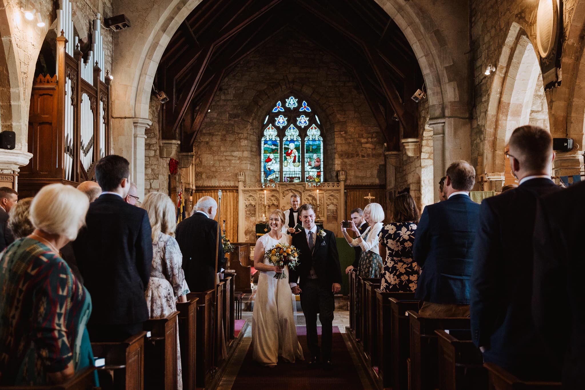 bride and groom leaving the church