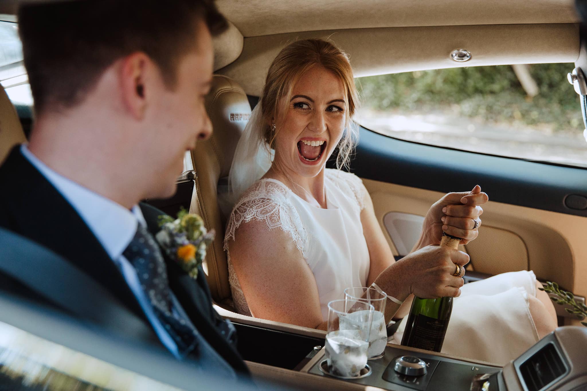 Norton Fields wedding bride and groom arriving in Aston Martin