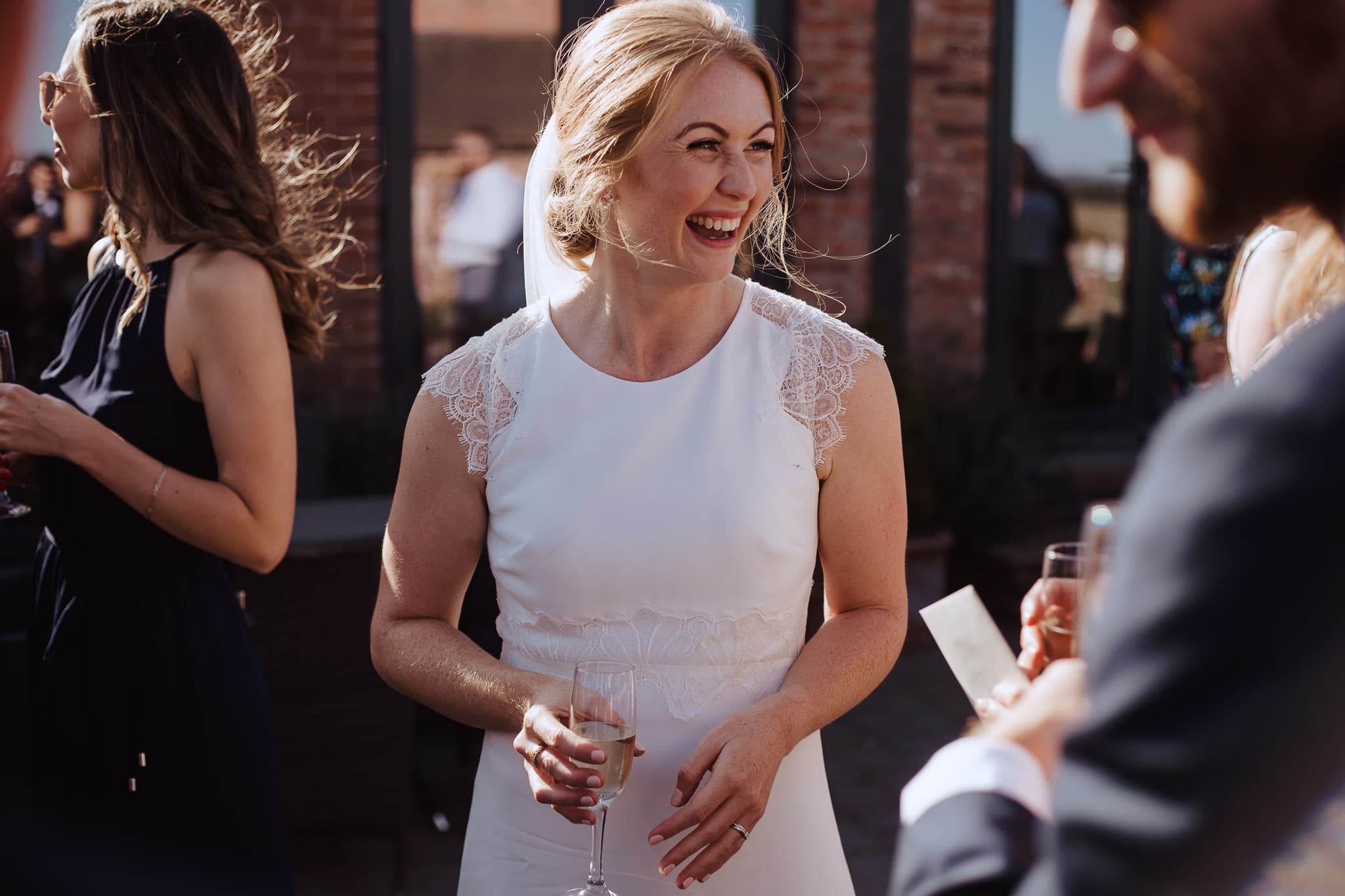 bride laughing with guests at Norton Fields wedding