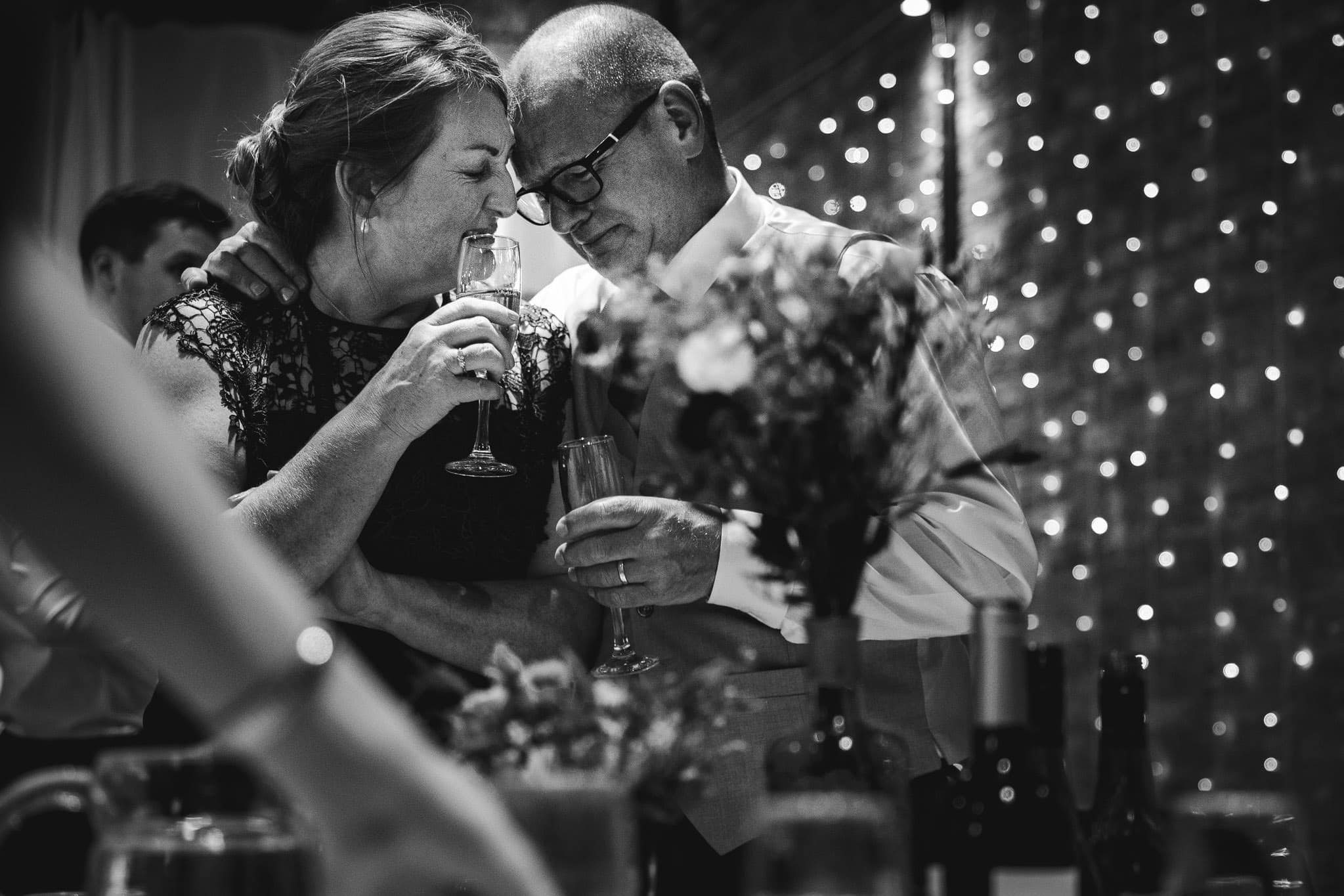 black and white photograph of mum and dad emotional during speeches