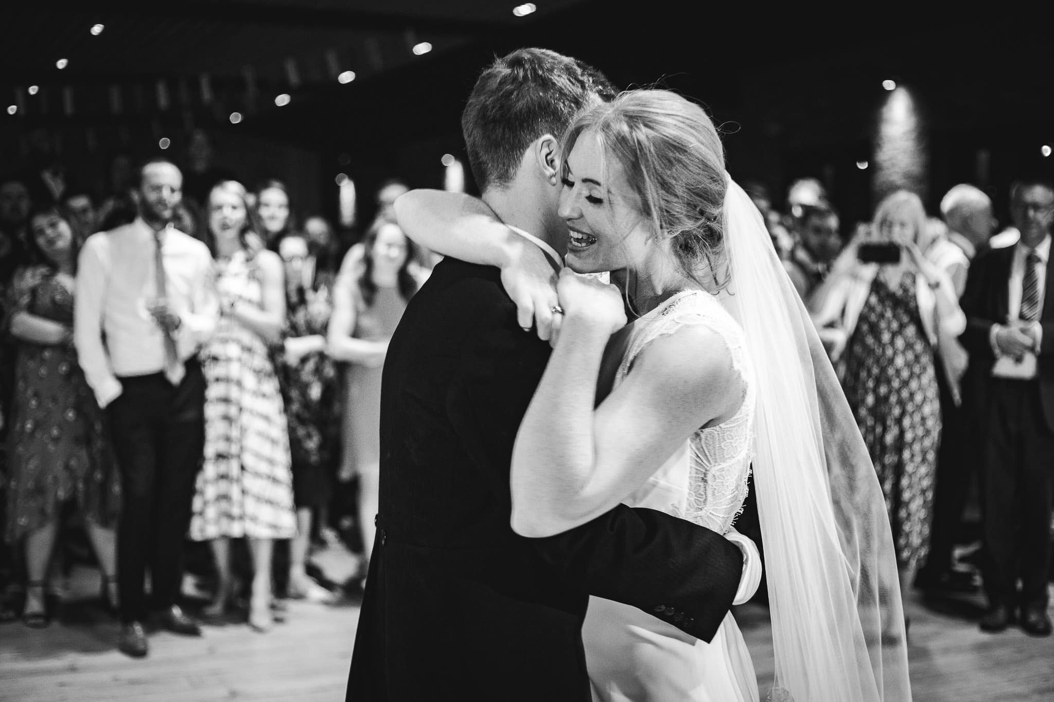 black and white photo of the bride and groom's first dance in the barn at Norton Fields
