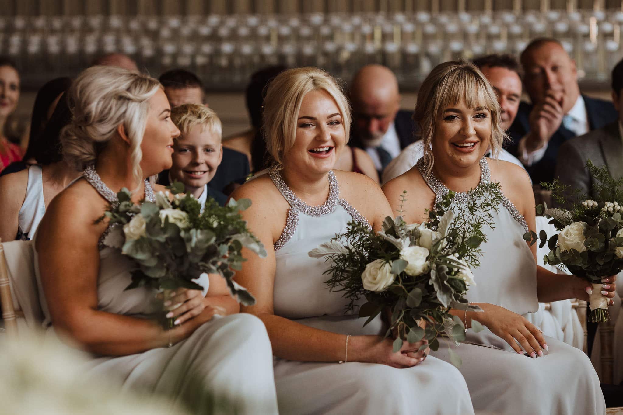bridesmaids laughing during wedding ceremony