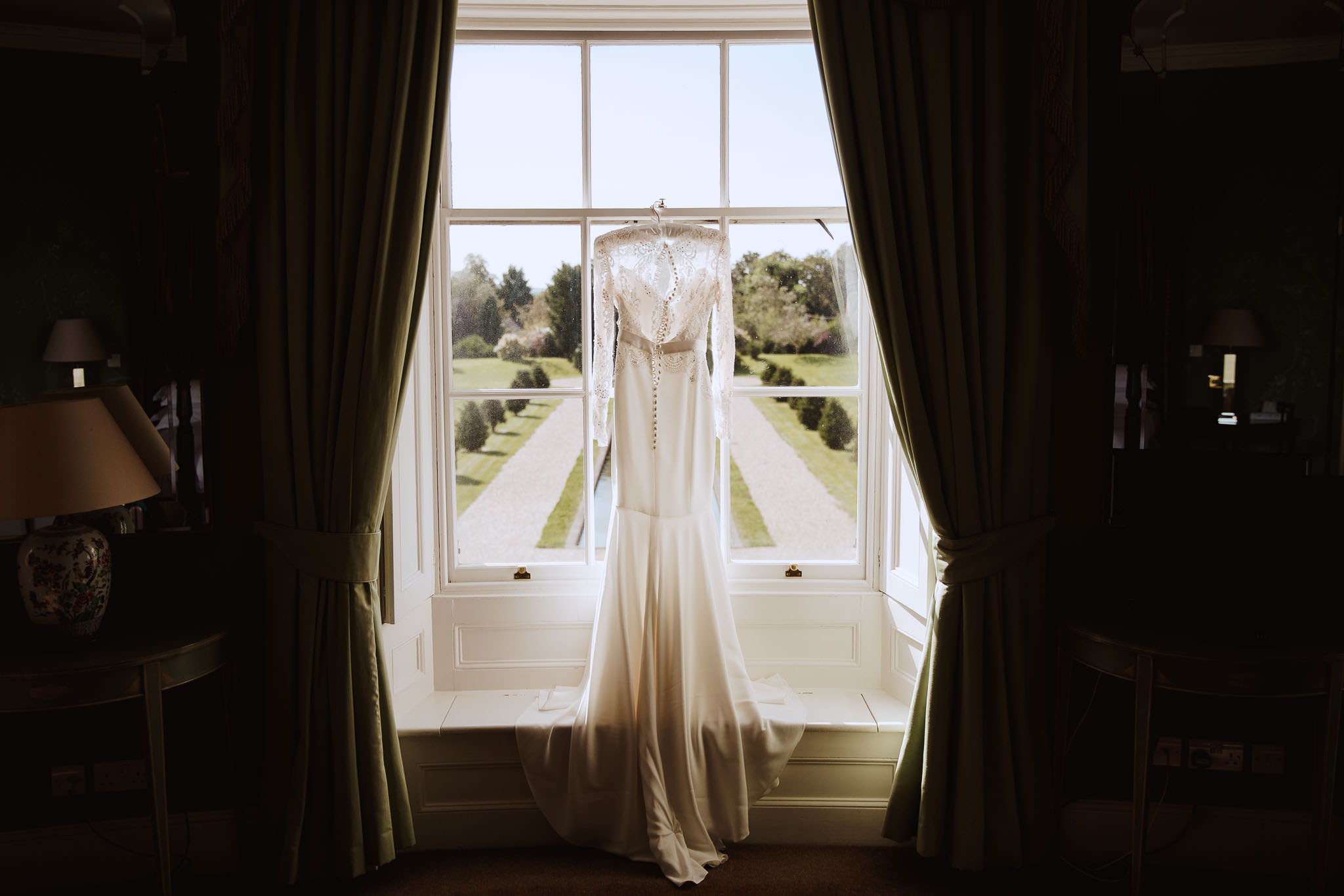 Suzanne Neville wedding dress hanging in the window of Stubton Hall