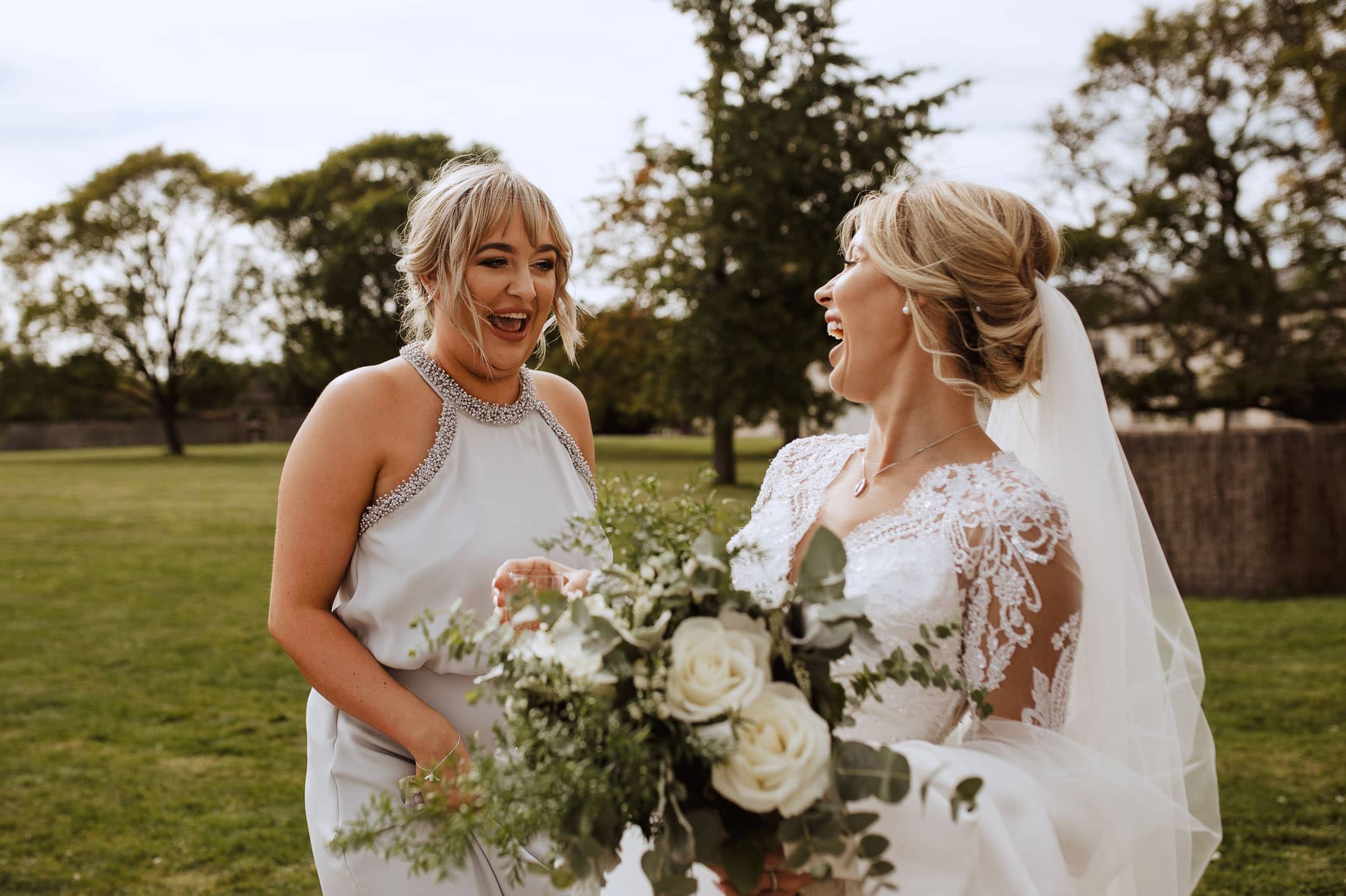 bride and bridesmaid sharing a joke