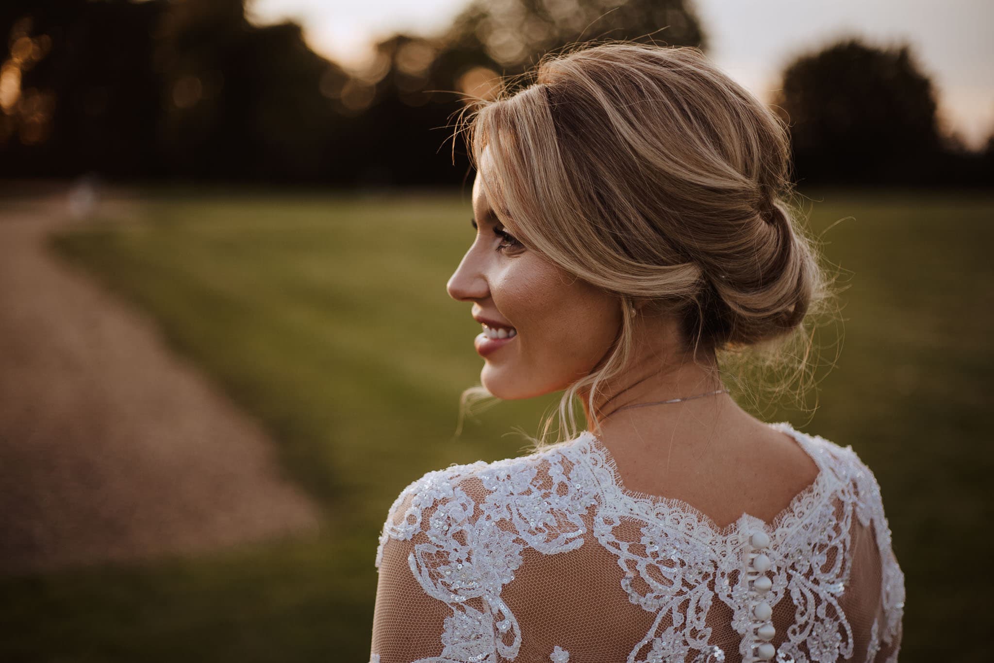 close up portrait of bride wearing lace back Suzanne Neville wedding dress