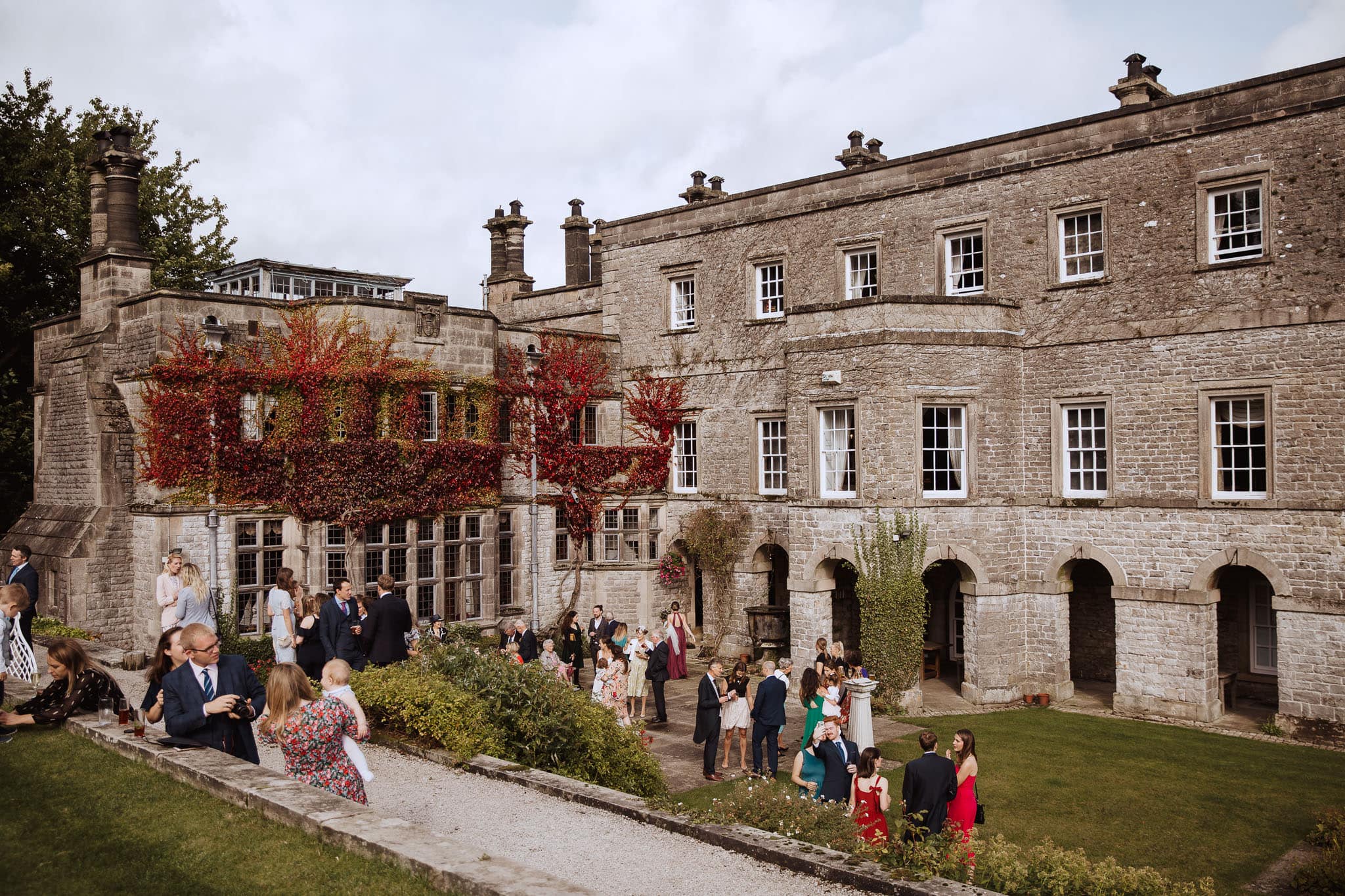 Tissington Hall Wedding guests in gardens