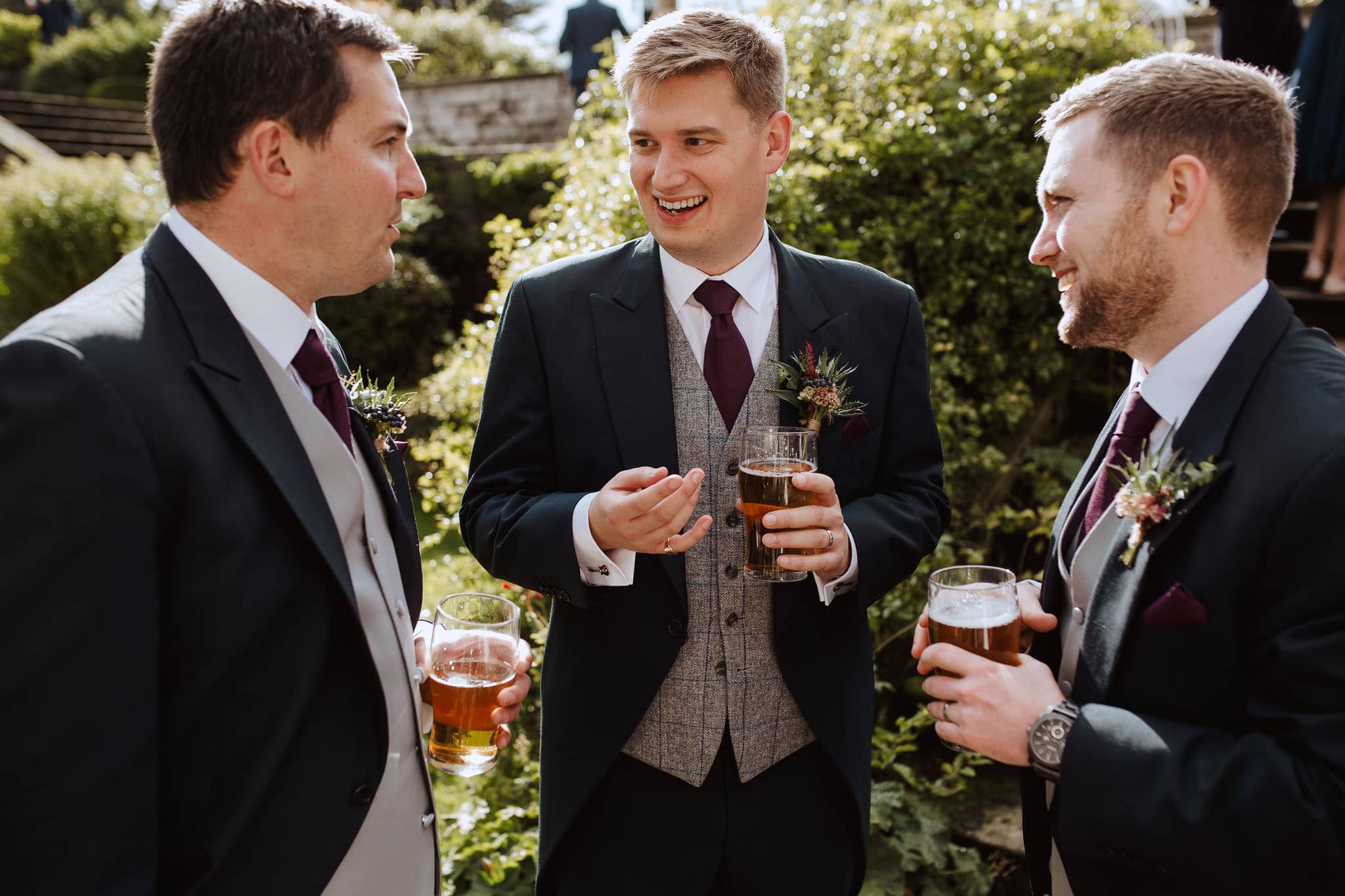 groom and groomsmen sharing a joke during drinks reception at Tissington Hall Wedding