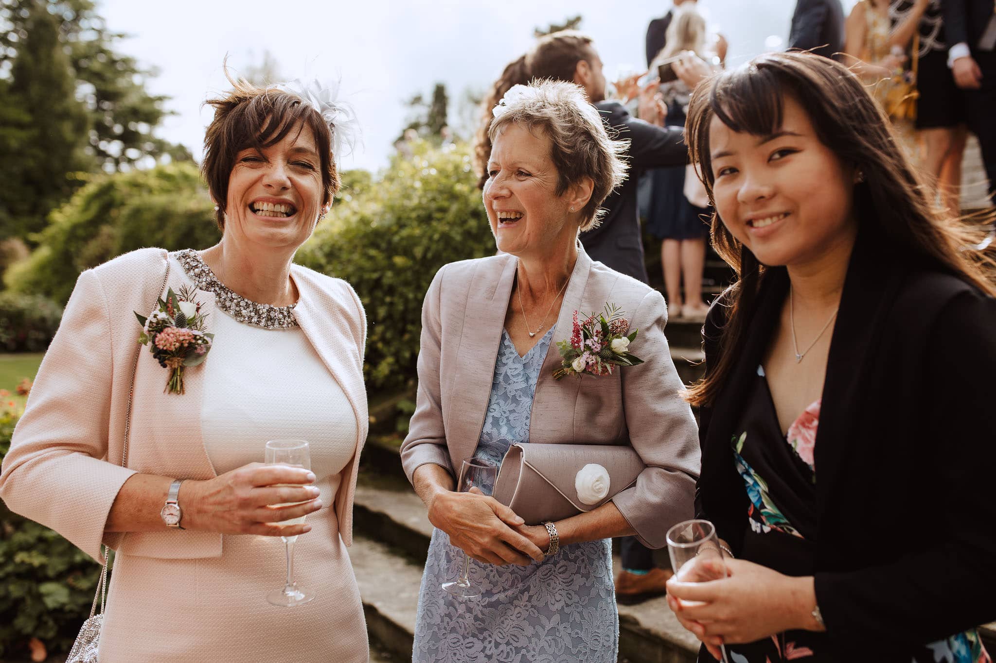 Mums laughing together during Tissington Hall wedding drinks reception