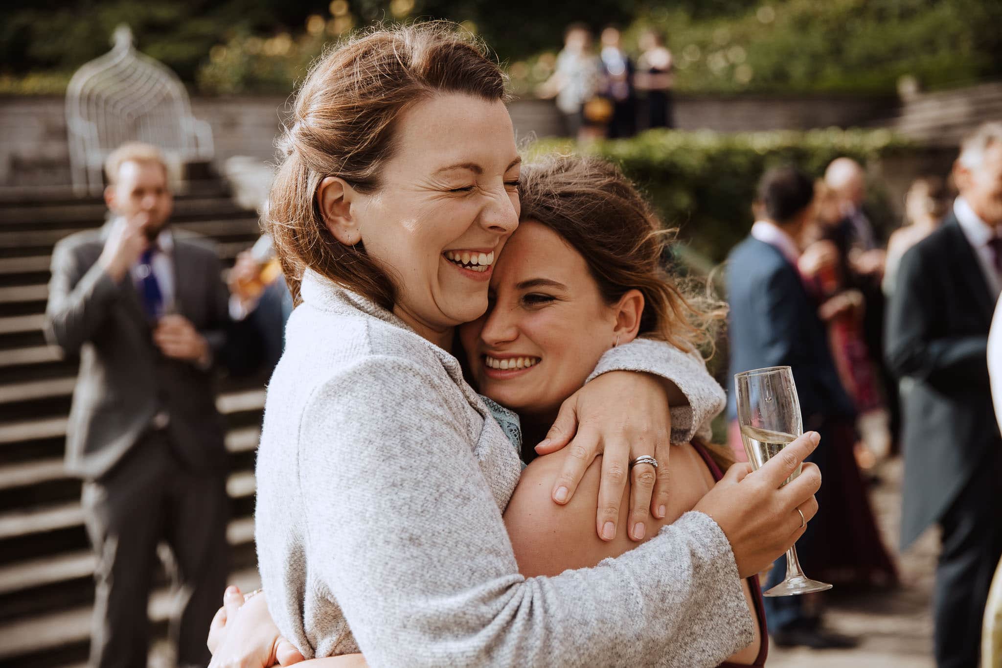 photojournalism Tissington Hall wedding guests hugging