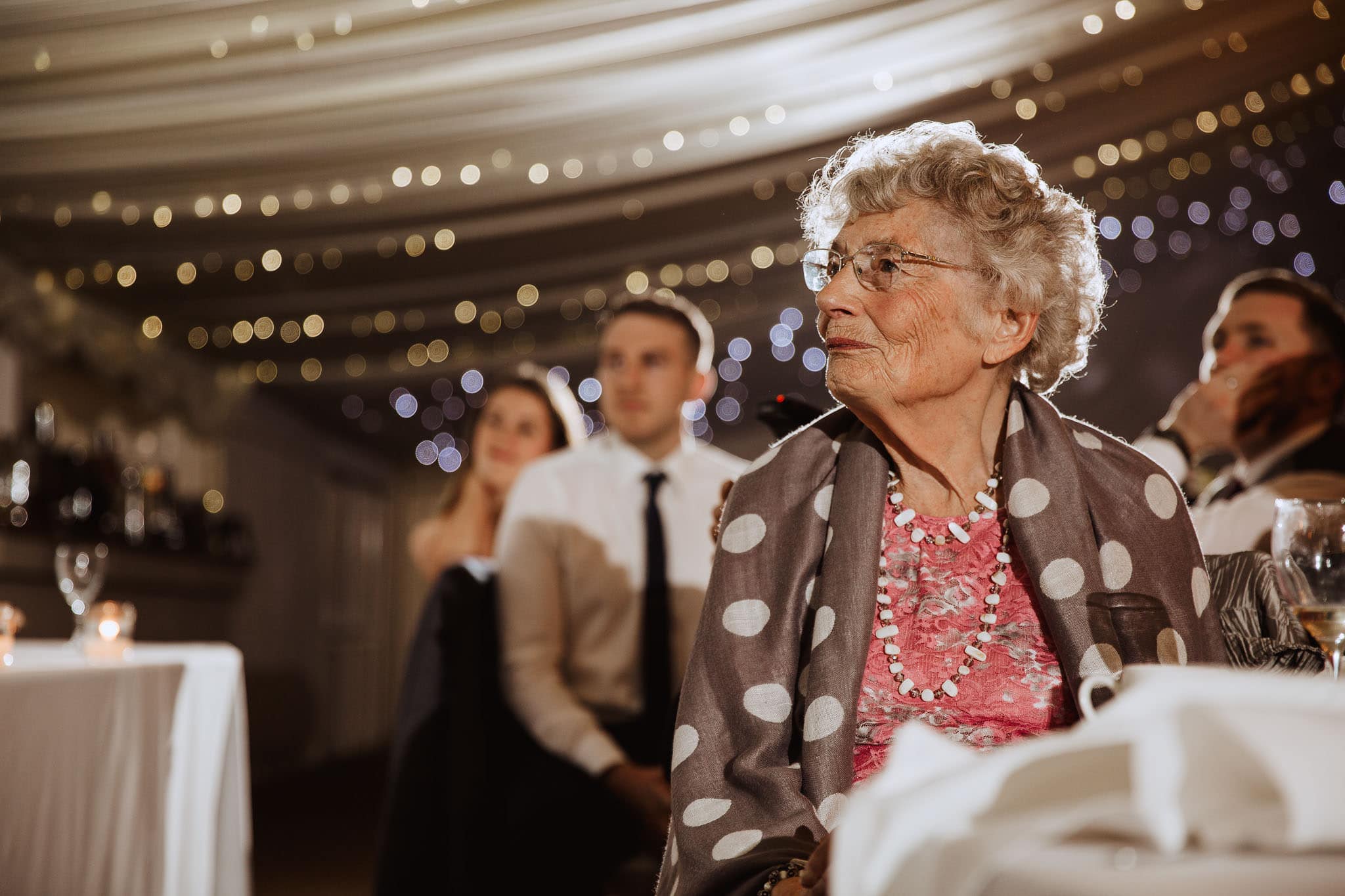 grandma intently listening to wedding speeches