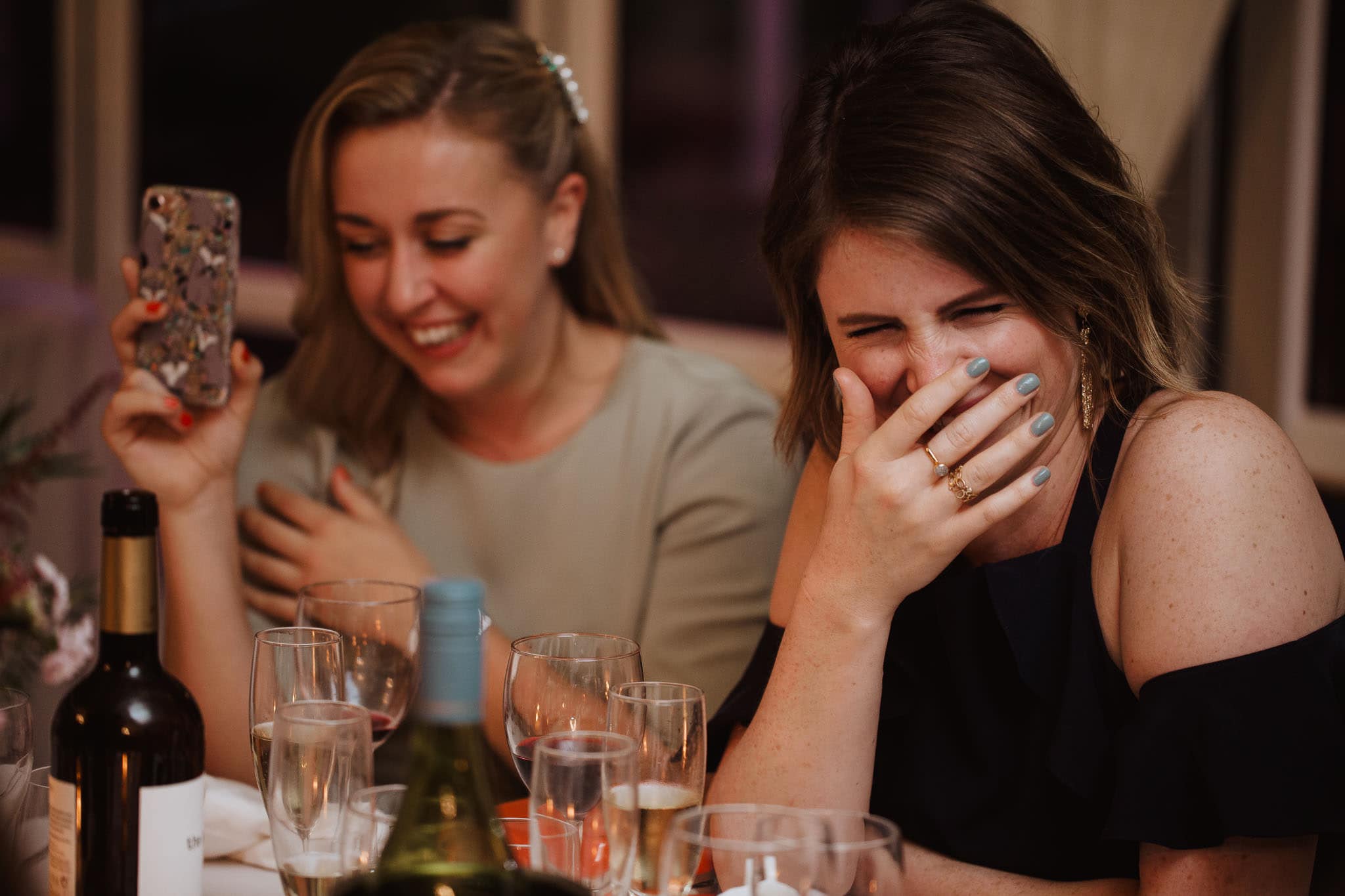 guests laughing hysterically at wedding speeches