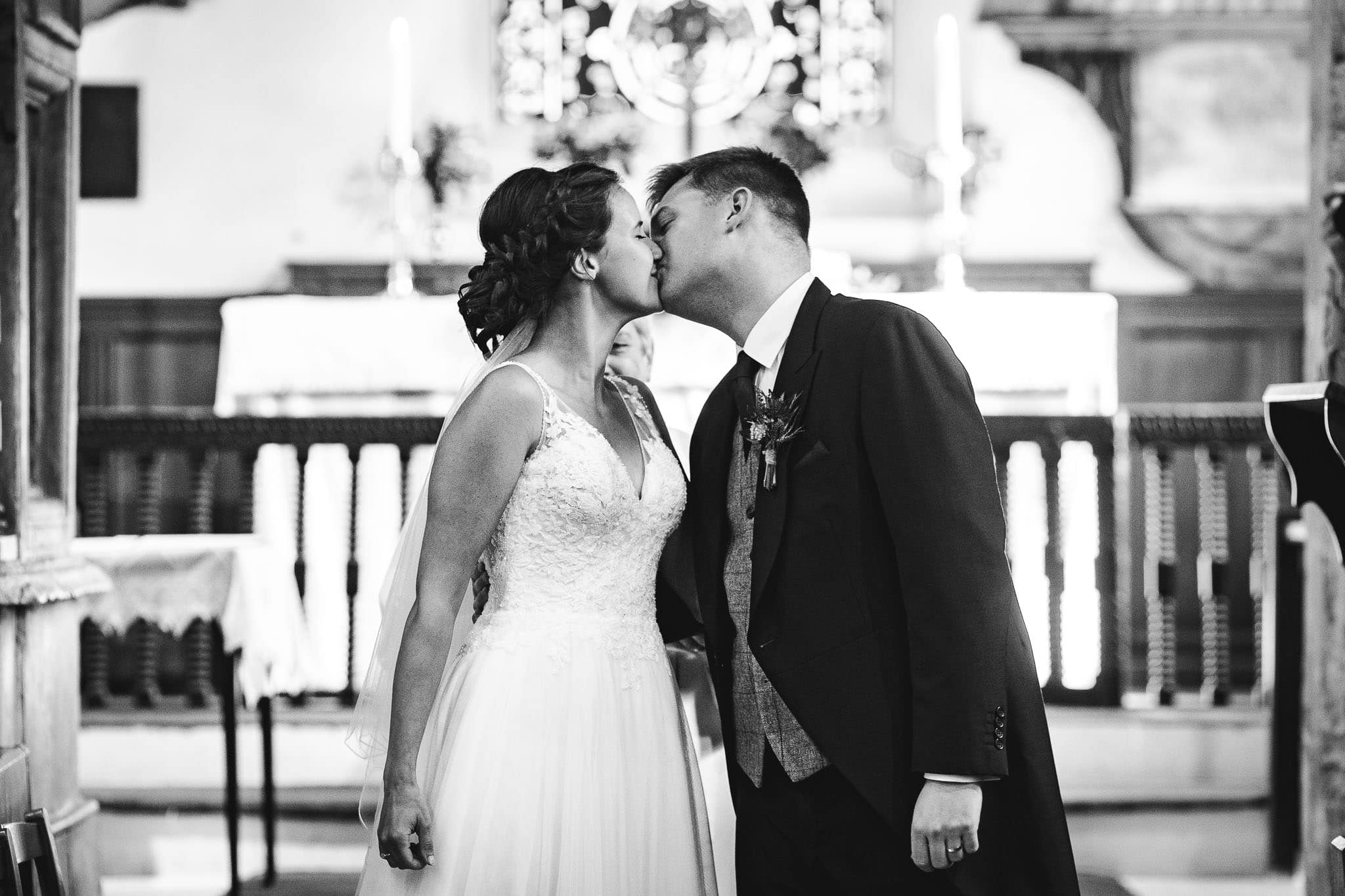 black and white close up photo of bride and groom's first kiss