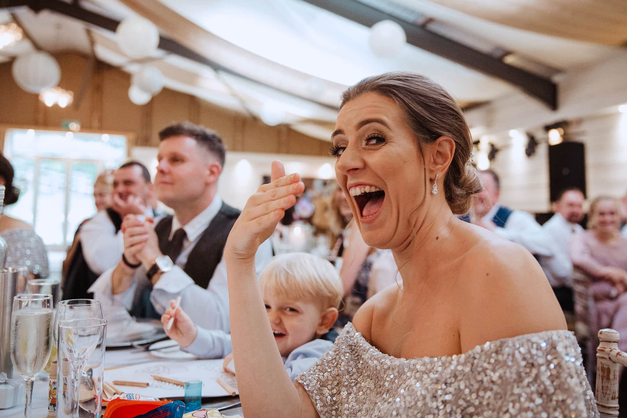 bridesmaid laughing during speeches at Newton House Barns Wedding