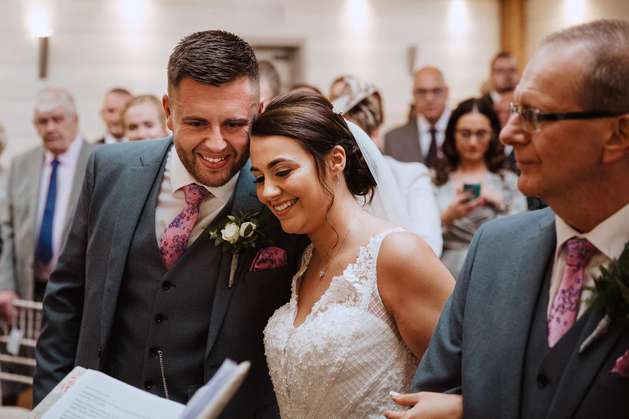 close up of an emotional groom greeting his bride at Newton House Barns Wedding ceremony