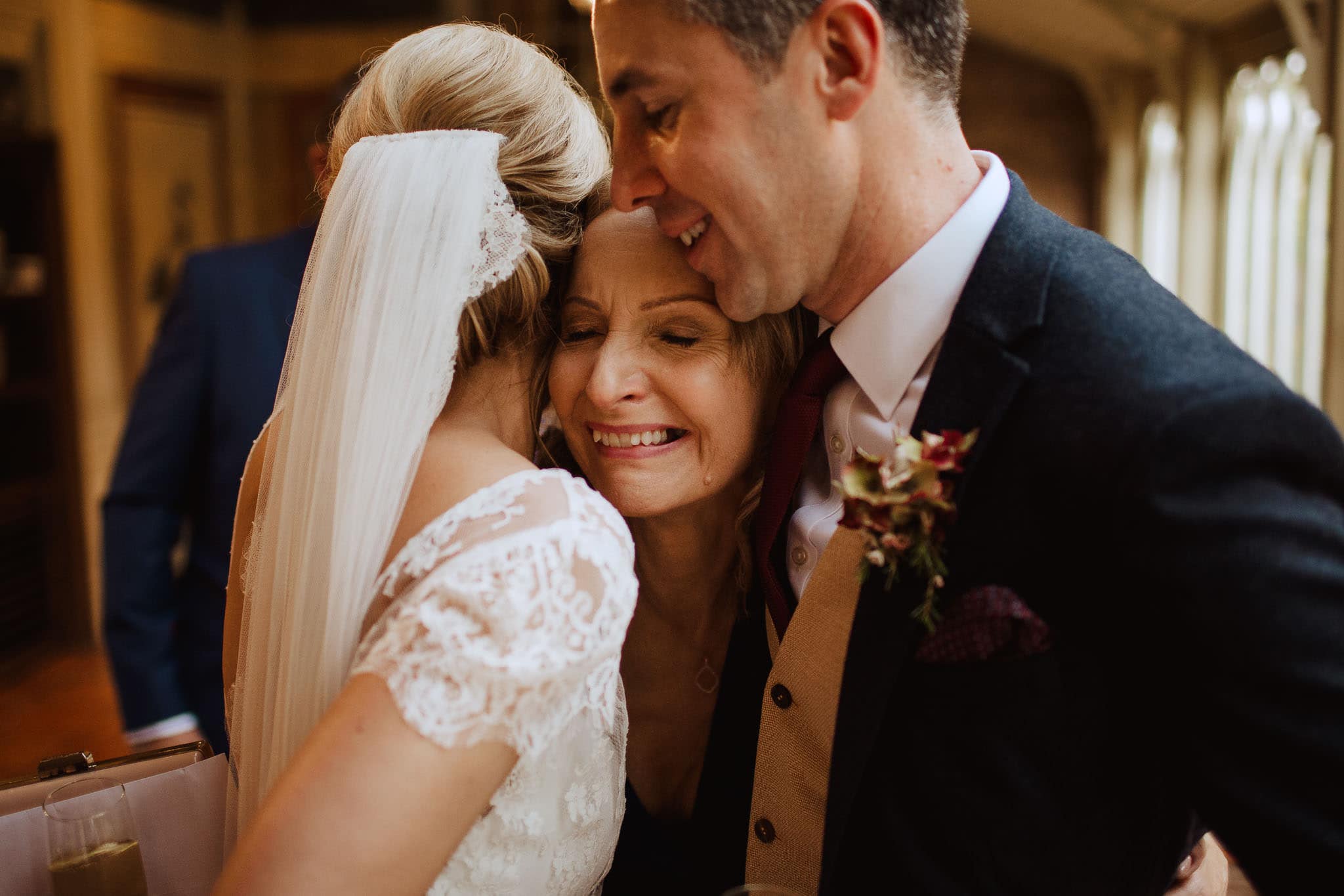 mother of the bride hugging captured by documentary wedding photographer, Dewsall Court
