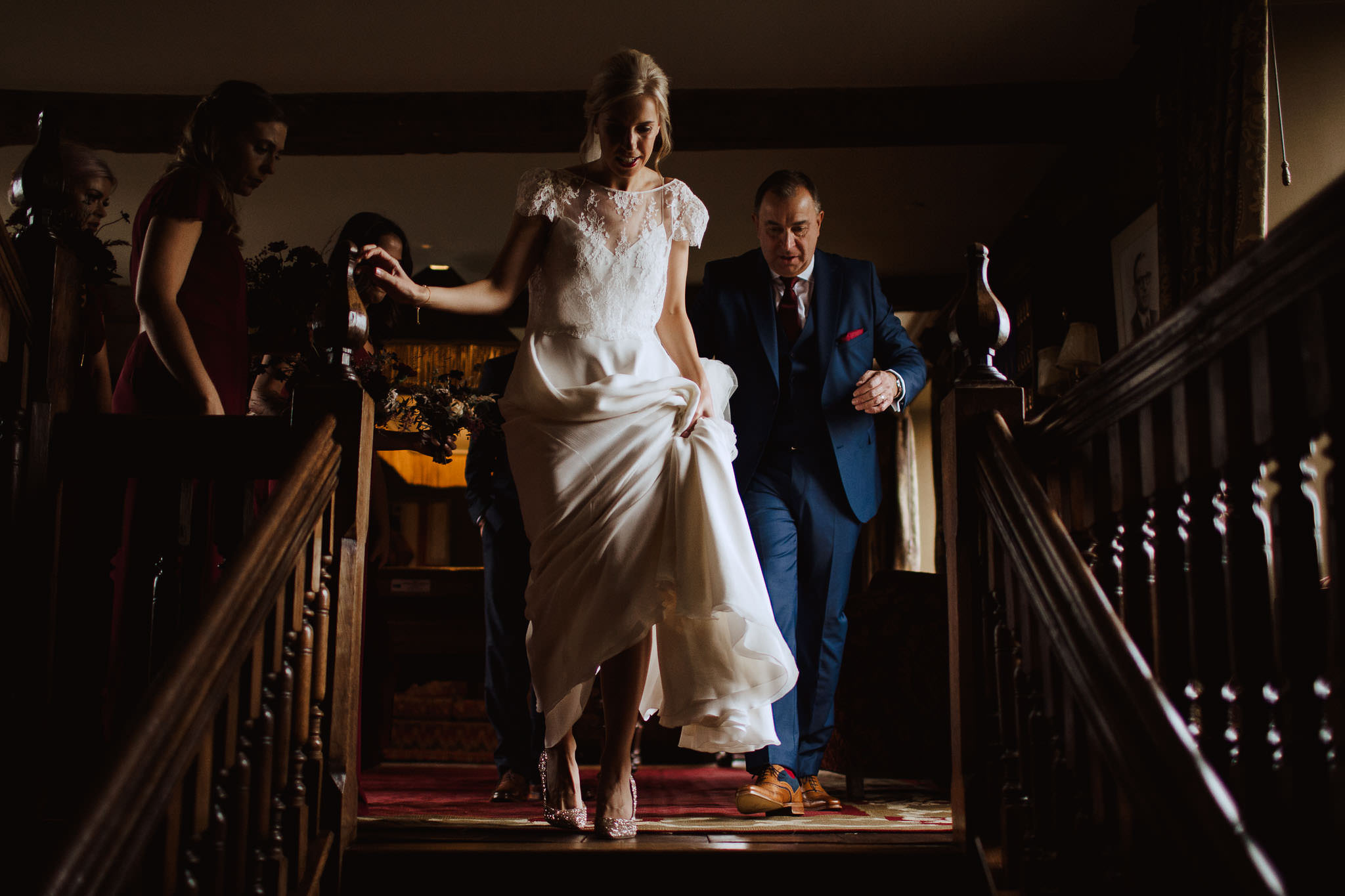 bride wearing Caroline Takvorian gown and Jimmy Choos captured in low light at Dewsall Court, Herefordshire