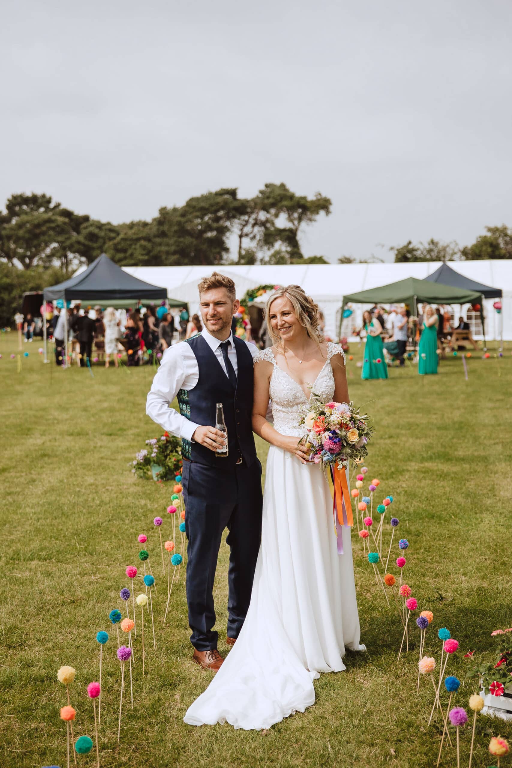 Charlotte and James admiring their colourful DIY wedding