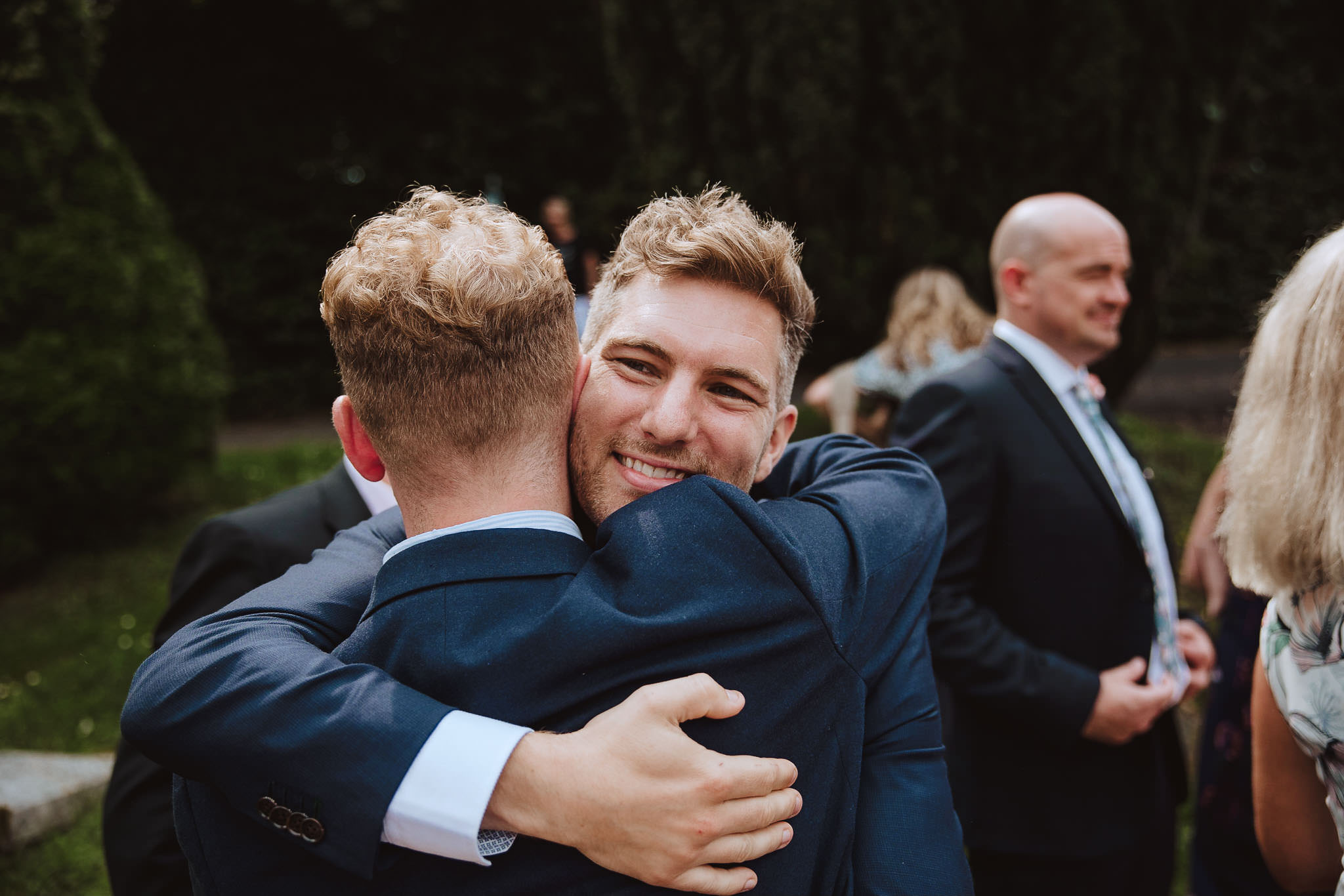 groom hugging guest