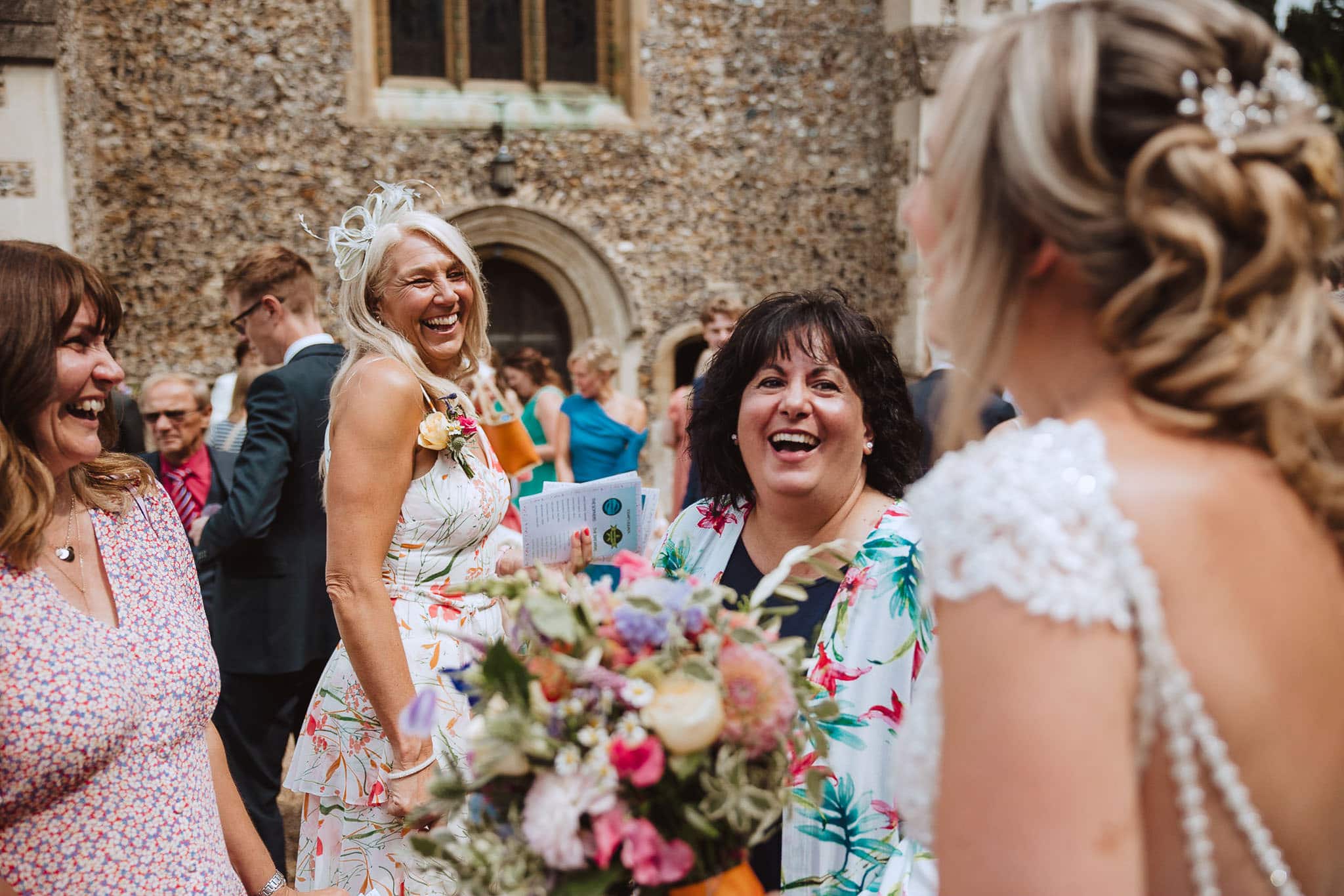 beautiful women laughing outside the church documentary wedding moments
