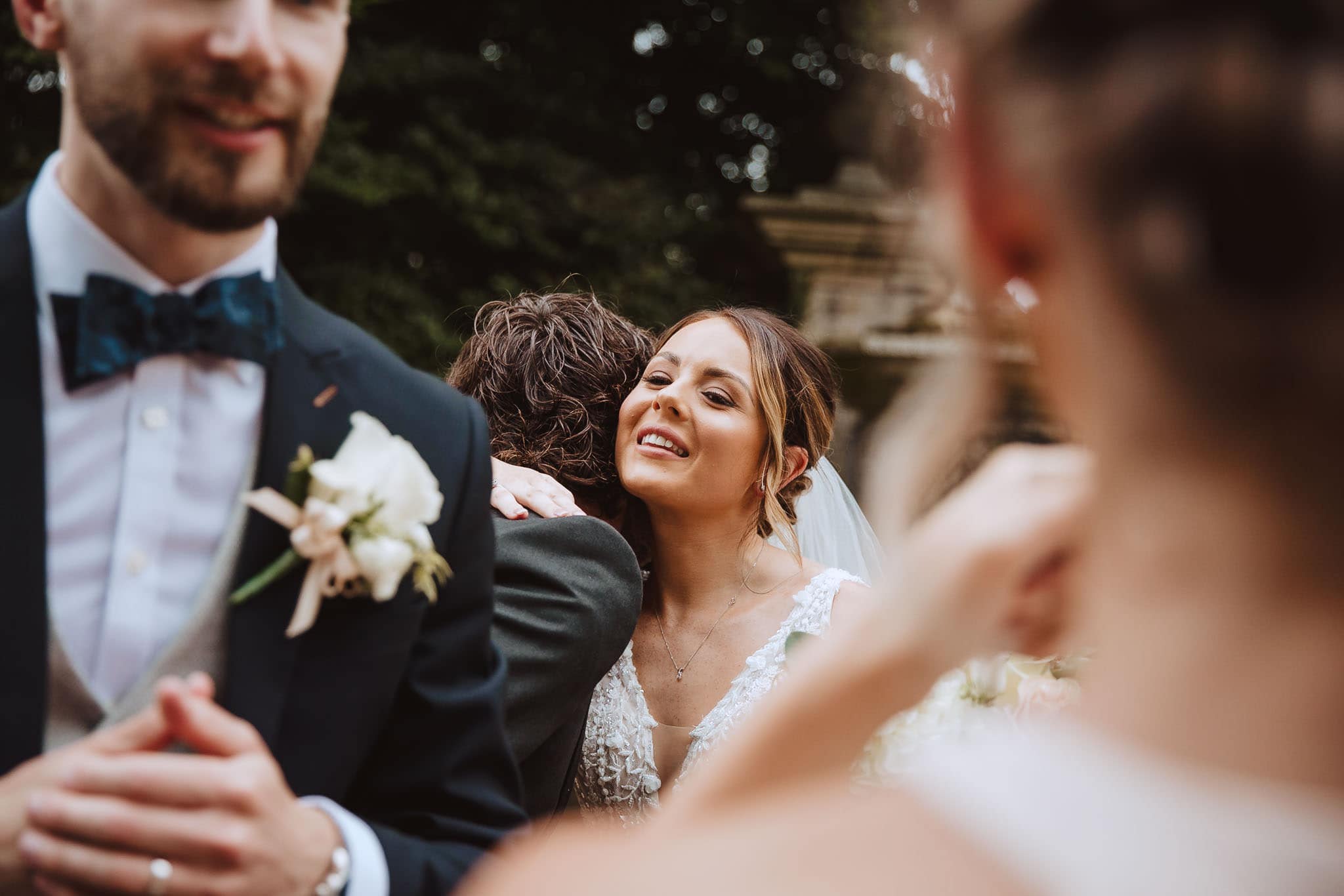 bride hugging guest by documentary photographers Red on Blonde