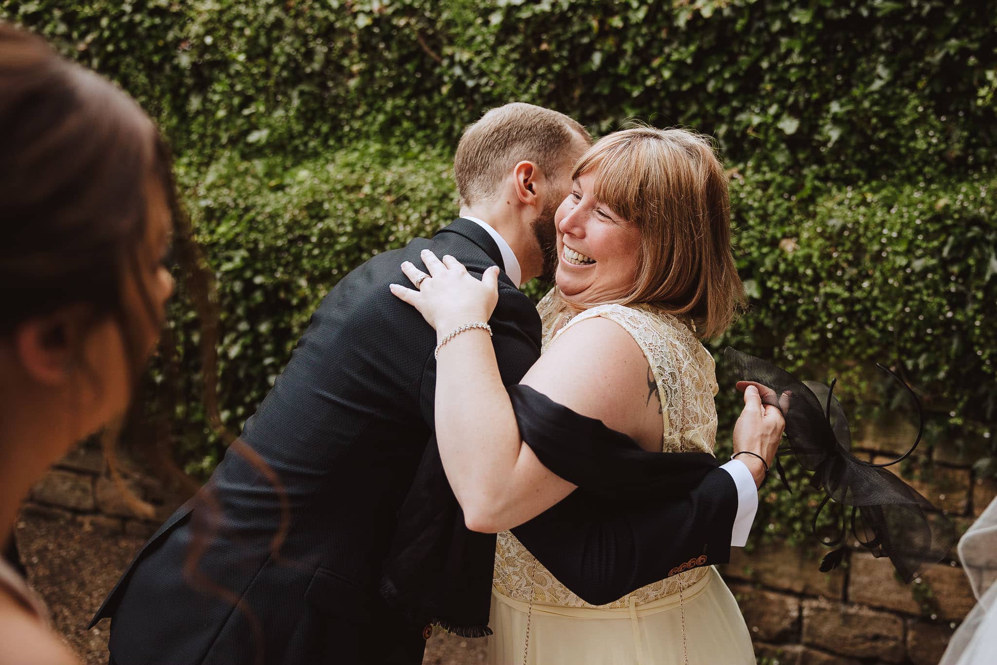 groom hugging guest