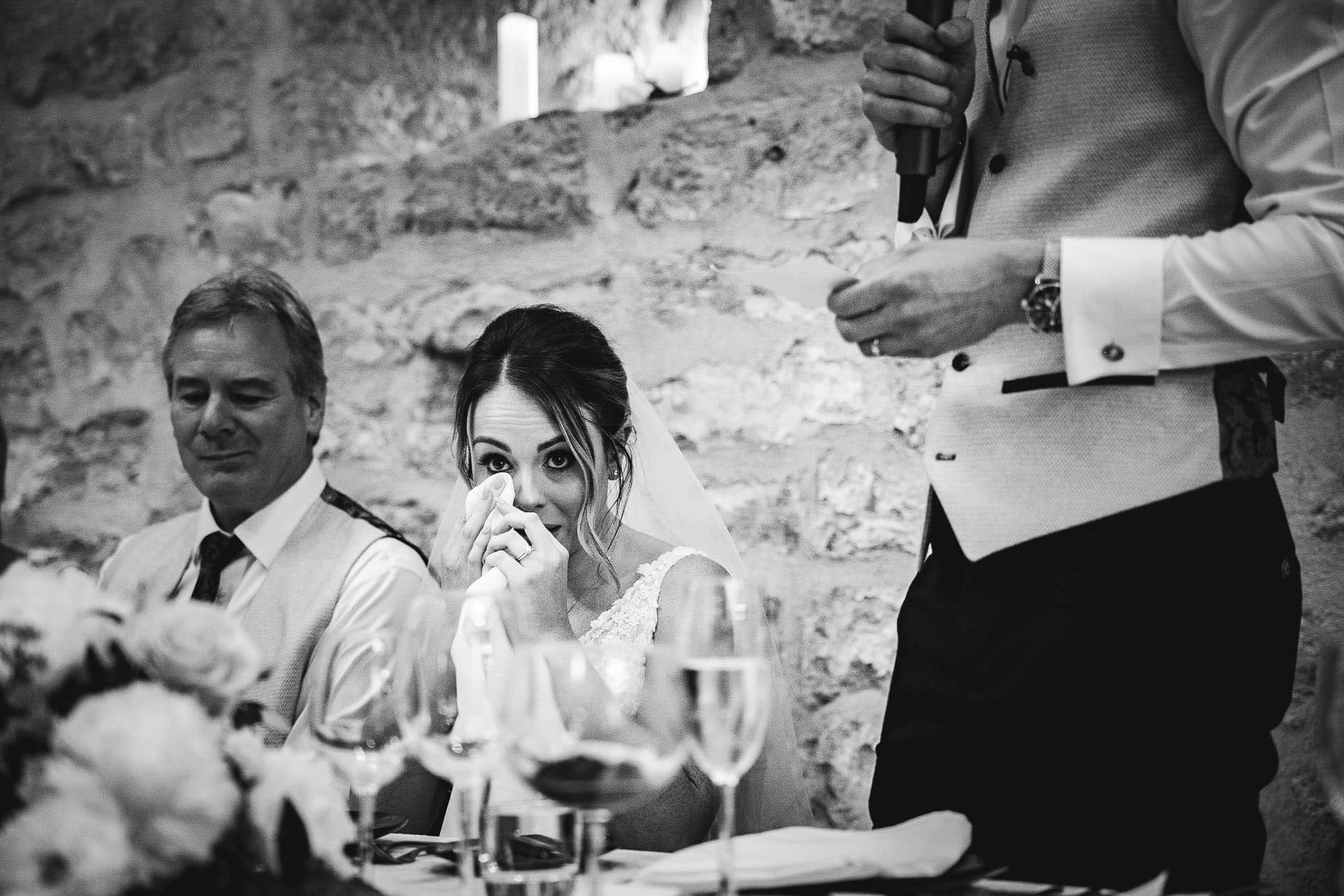 black and white photo of emotional bride during speeches at Hooton Pagnell Hall wedding