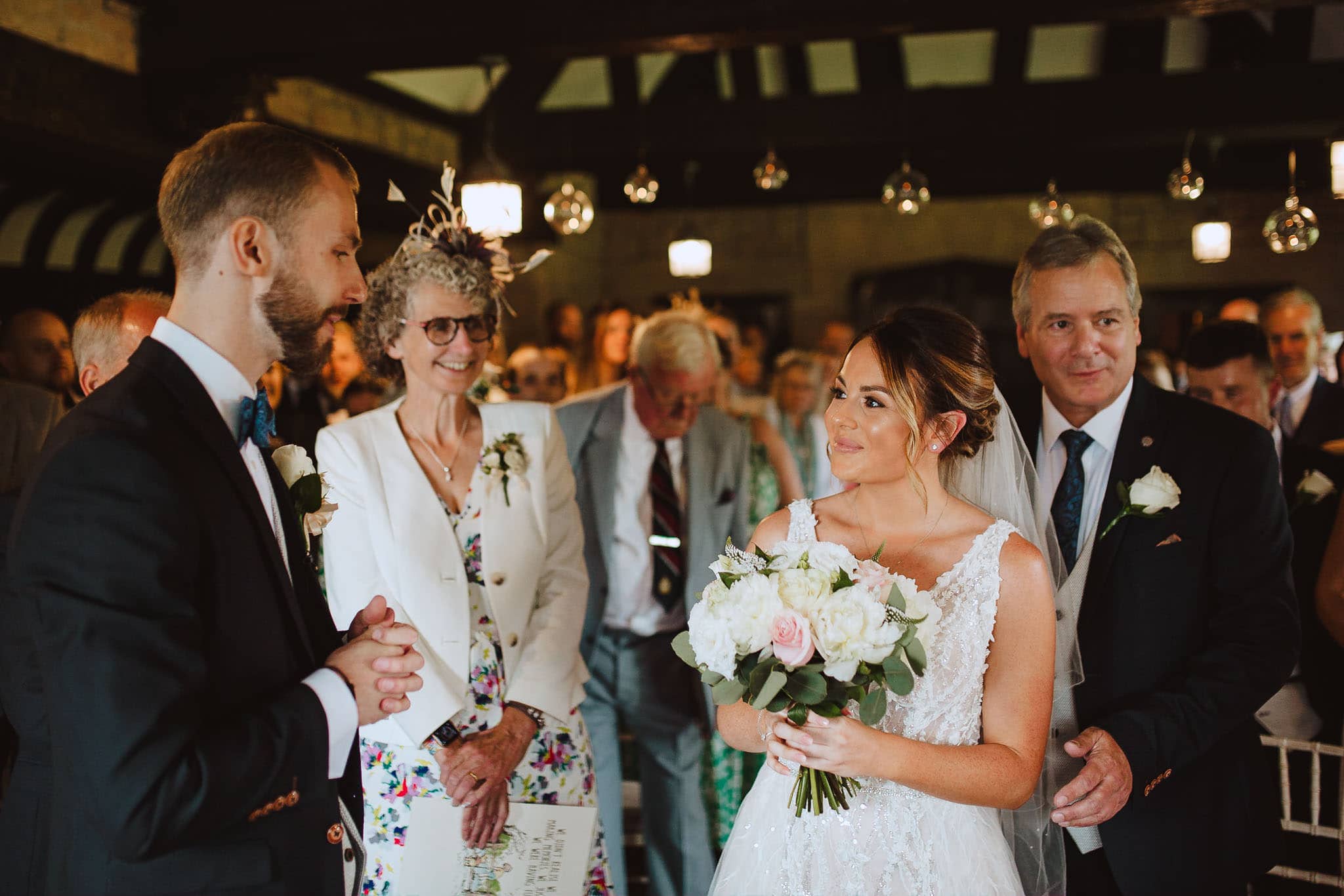 Red on Blonde Photography wedding ceremony bride greets groom