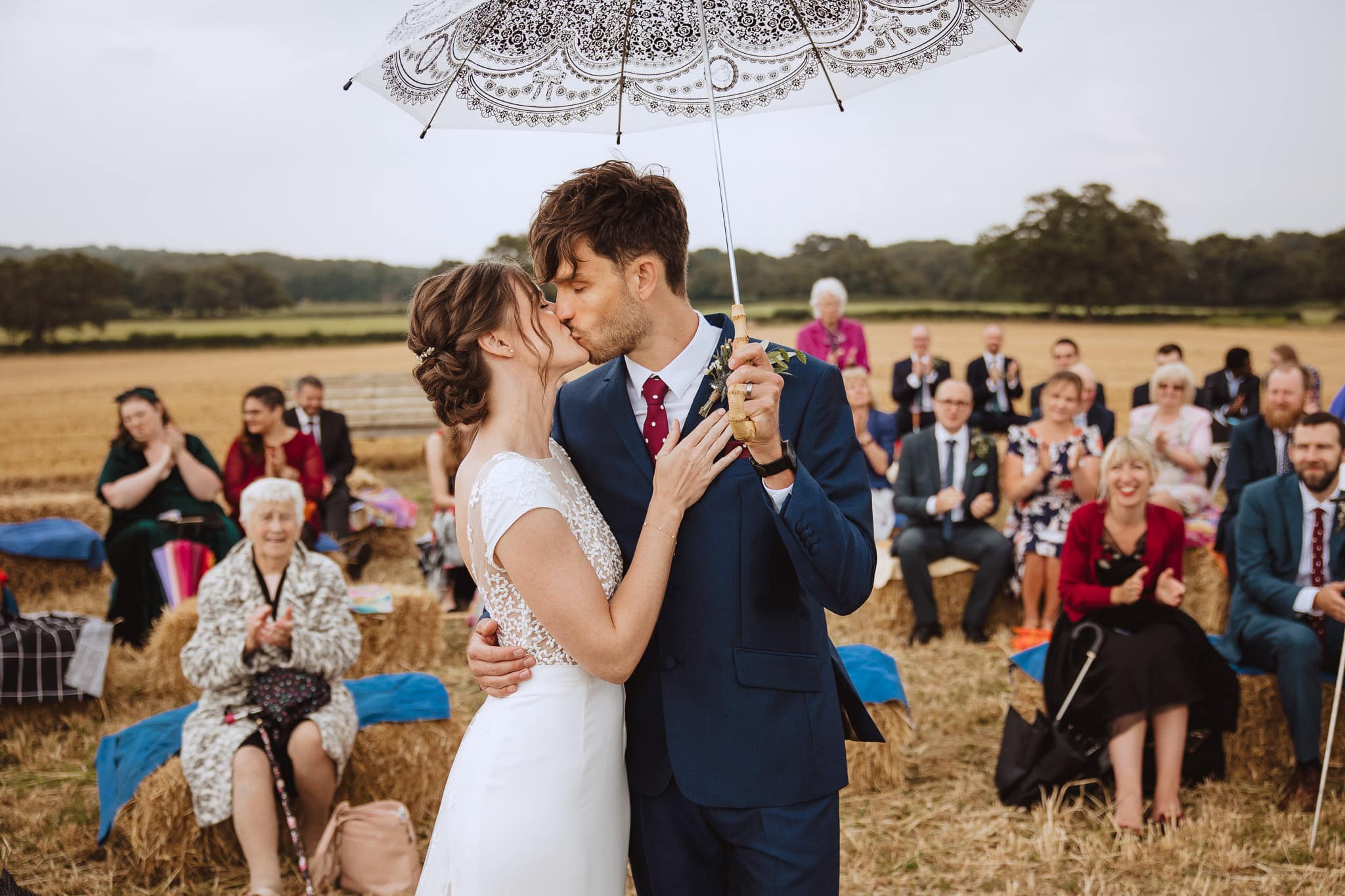 bride and groom's first kiss after their outdoor ceremony
