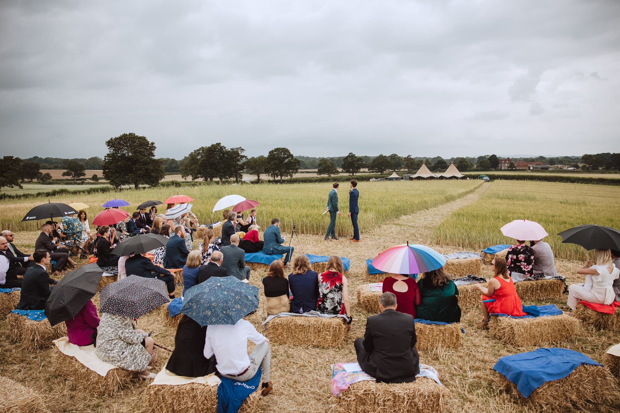 outdoor ceremony set up in a field on a rainy day